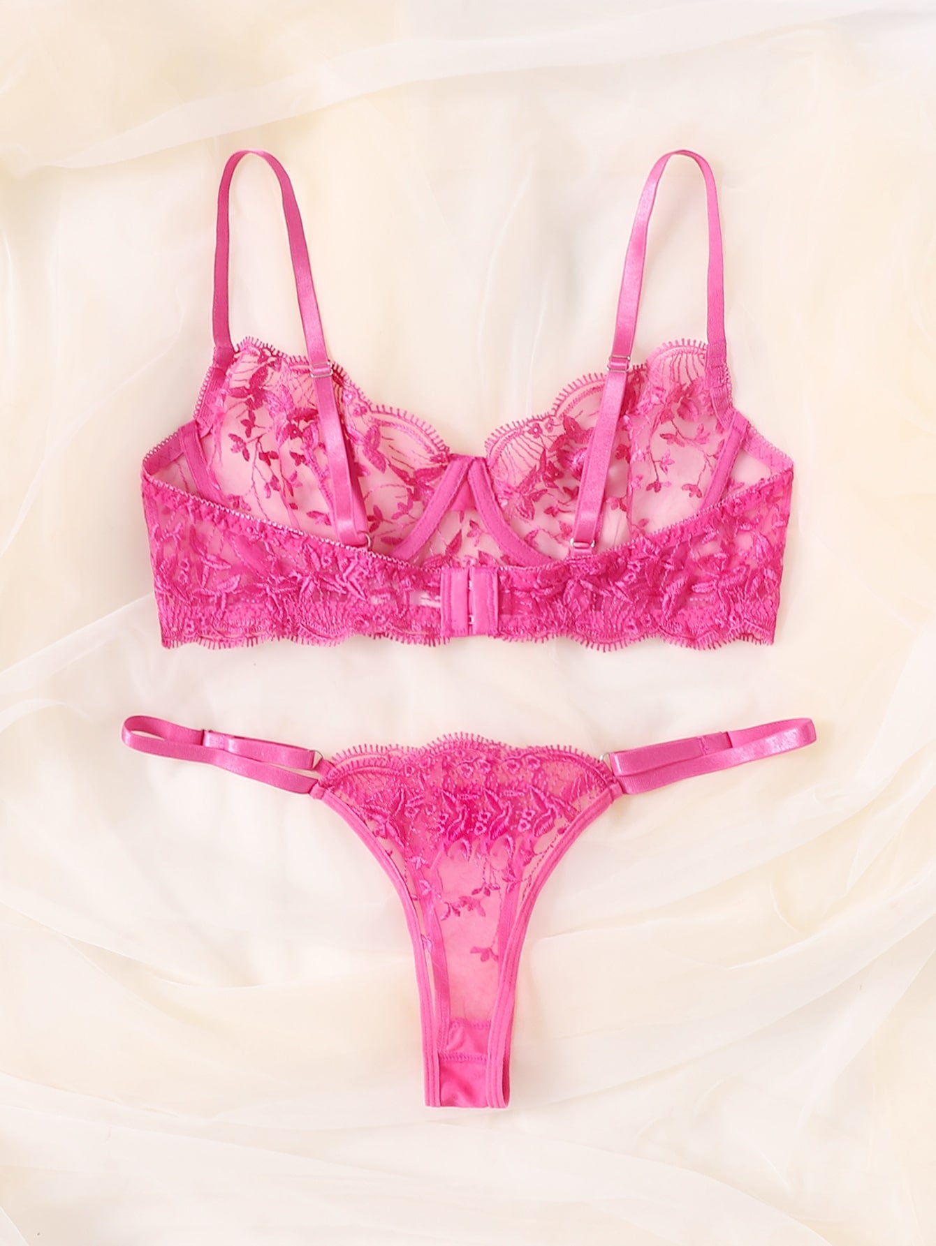Two-piece women’s lingerie set featuring embroidered sheer mesh, an underwire bra with adjustable spaghetti straps, and a matching low-rise thong panty. Classic sexy style with slight stretch fabric.