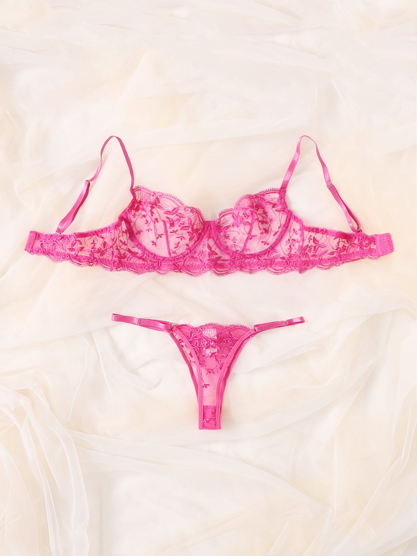 Two-piece women’s lingerie set featuring embroidered sheer mesh, an underwire bra with adjustable spaghetti straps, and a matching low-rise thong panty. Classic sexy style with slight stretch fabric.