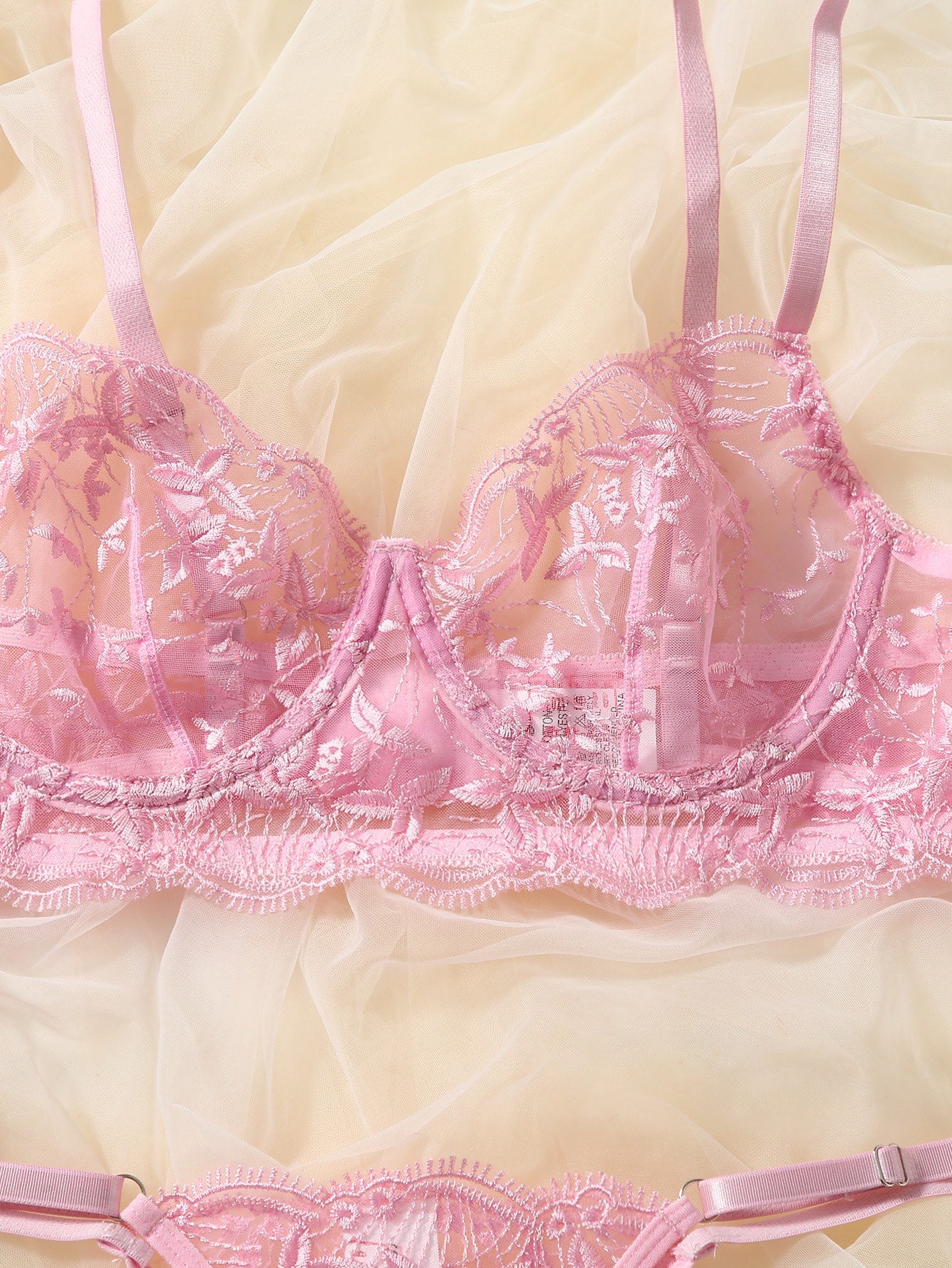 Pink semi-sheer mesh lingerie set with leaf embroidery, underwire demi bra, adjustable spaghetti straps, and matching low-rise V-string panty
