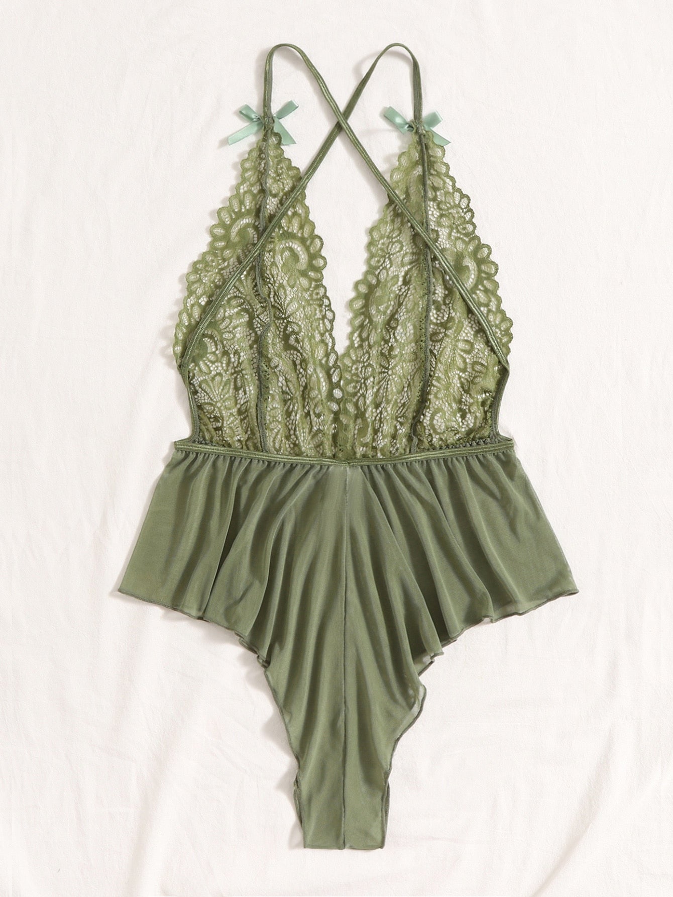 Sheer mesh teddy bodysuit lingerie with contrast lace detailing, spaghetti straps, criss-cross back, backless design, bow accent, and V-string cut.