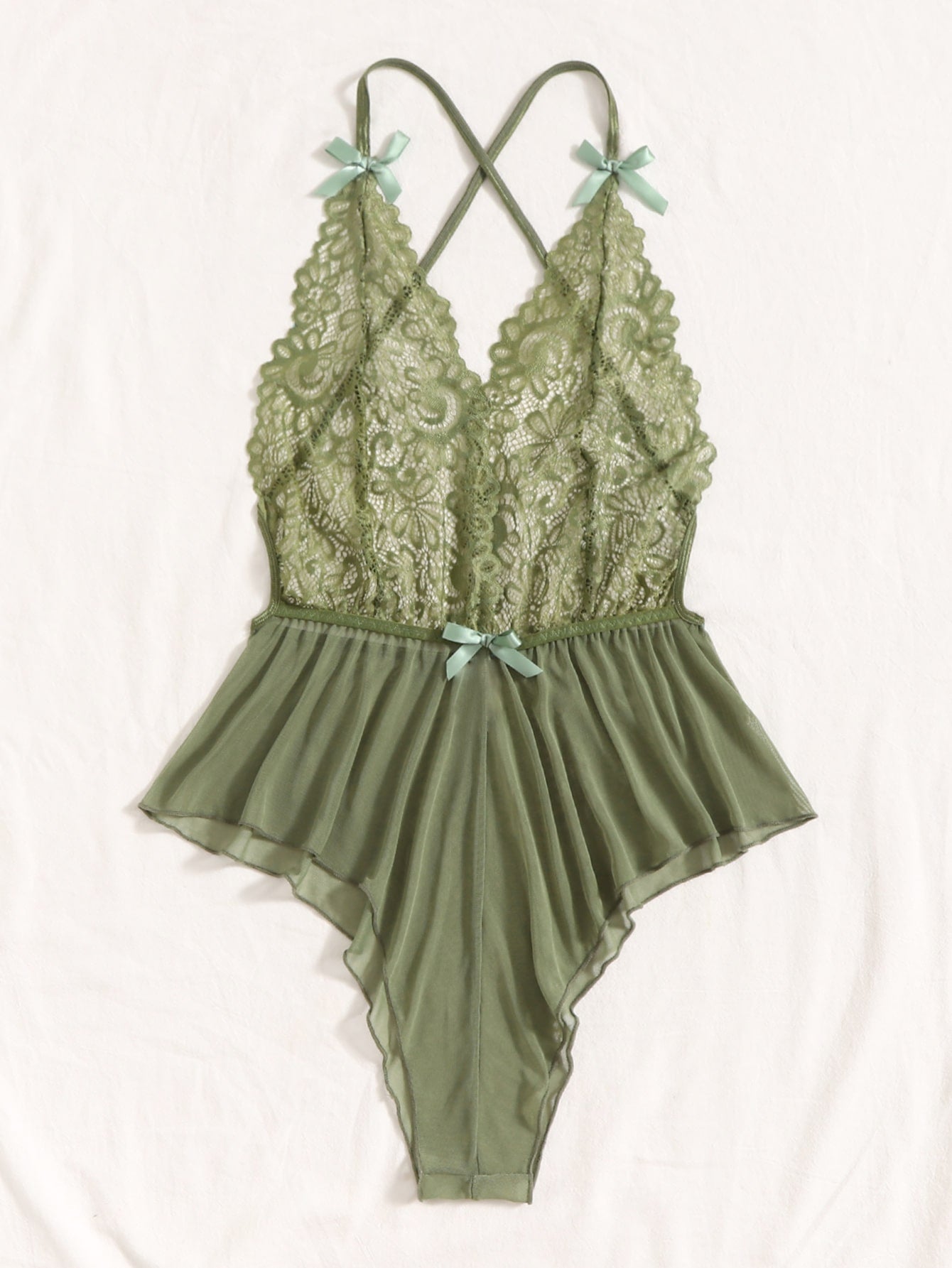 Sheer mesh teddy bodysuit lingerie with contrast lace detailing, spaghetti straps, criss-cross back, backless design, bow accent, and V-string cut.