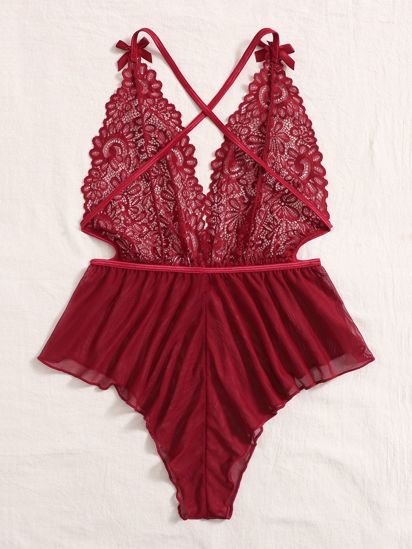 Sheer mesh teddy bodysuit lingerie with contrast lace detailing, spaghetti straps, criss-cross back, backless design, bow accent, and V-string cut.