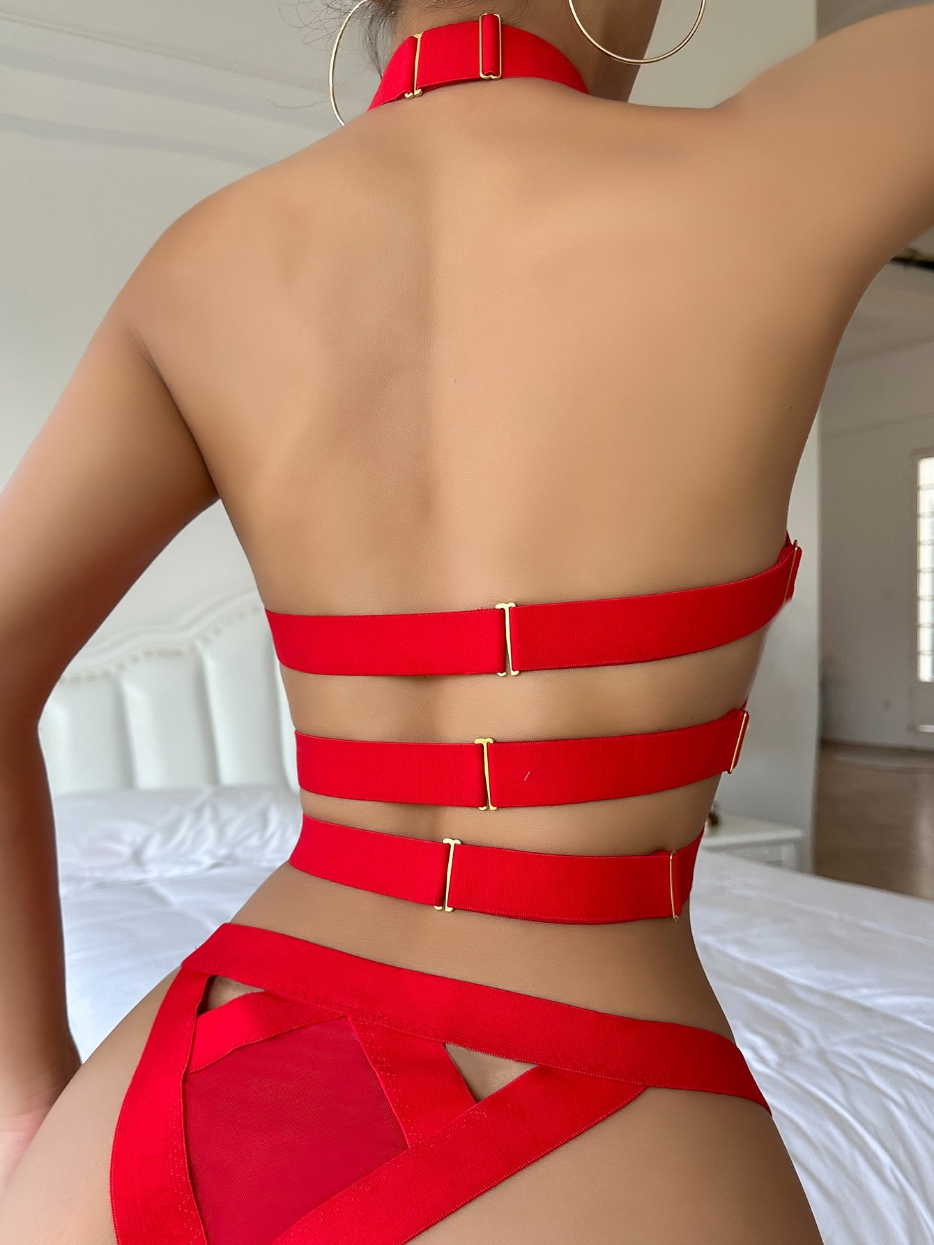 Women’s 4-piece solid cut-out garter lingerie set with halter bralette and thong, includes 1 pair of leg rings; plain ultra-sexy style in slight-stretch fabric, available in red and royal blue.