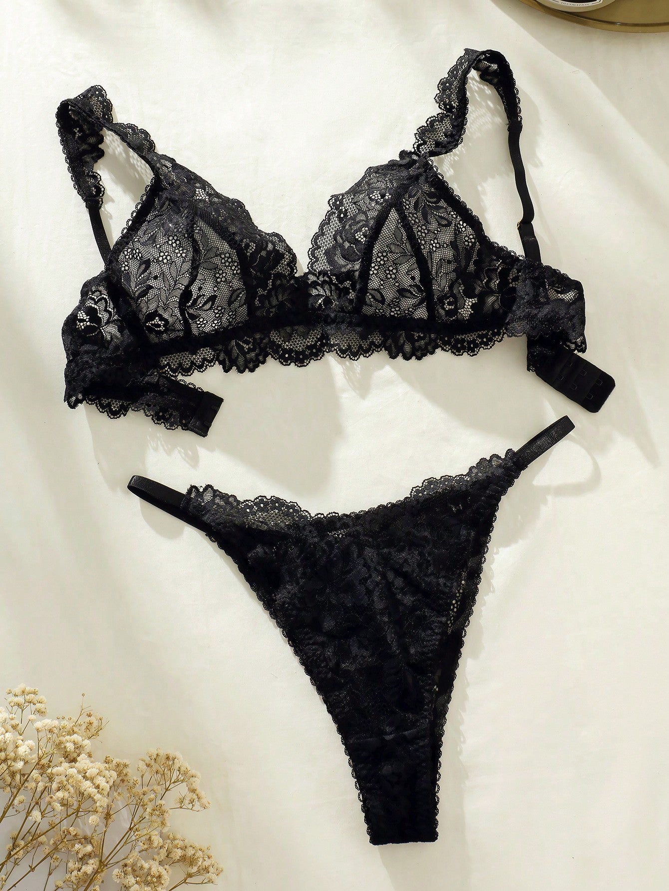 Women's floral lace lingerie set featuring a camisole-style wireless bra with adjustable straps and matching mid-rise briefs, designed with contrast scalloped lace and light support.
