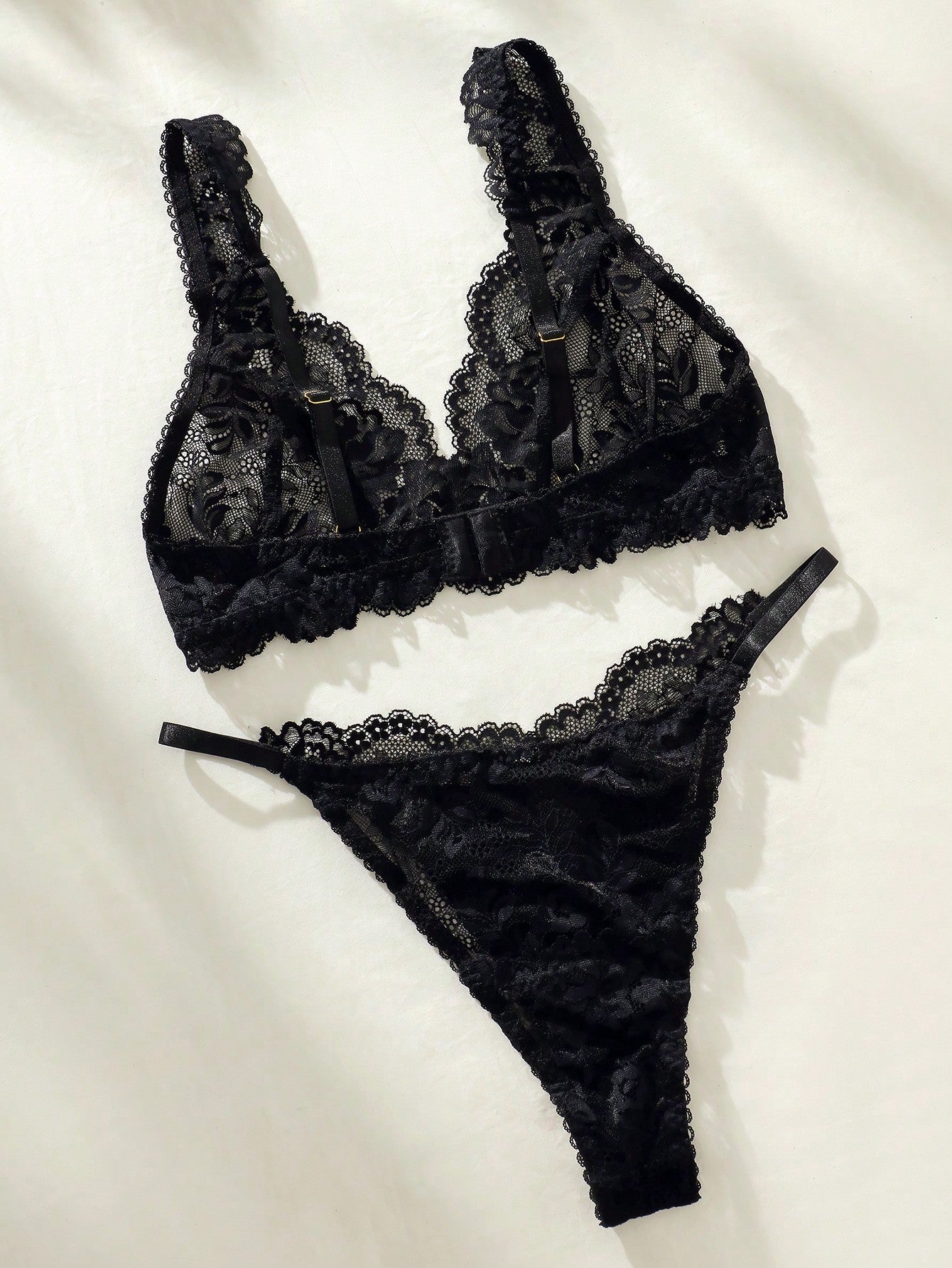 Women's floral lace lingerie set featuring a camisole-style wireless bra with adjustable straps and matching mid-rise briefs, designed with contrast scalloped lace and light support.