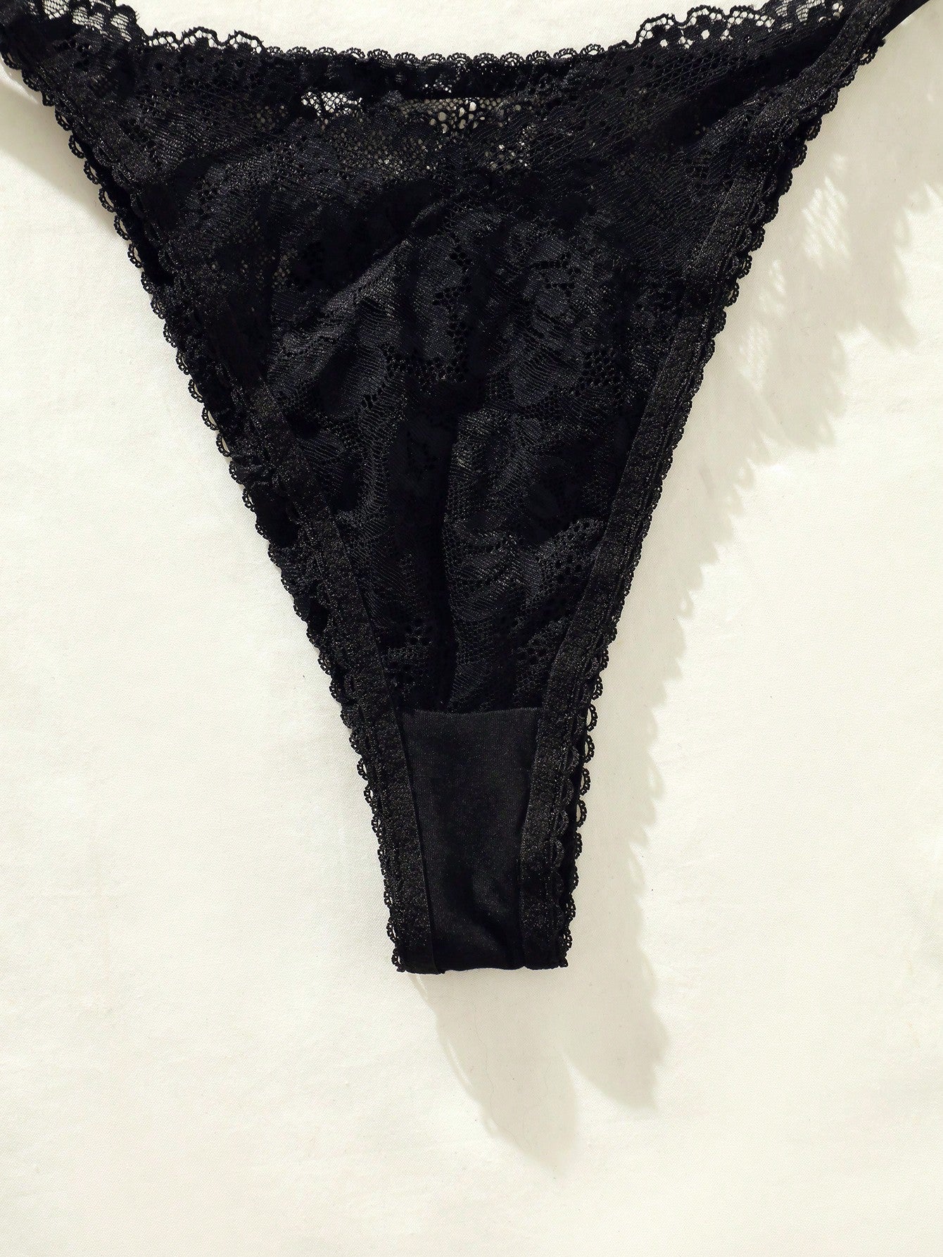Women's floral lace lingerie set featuring a camisole-style wireless bra with adjustable straps and matching mid-rise briefs, designed with contrast scalloped lace and light support.