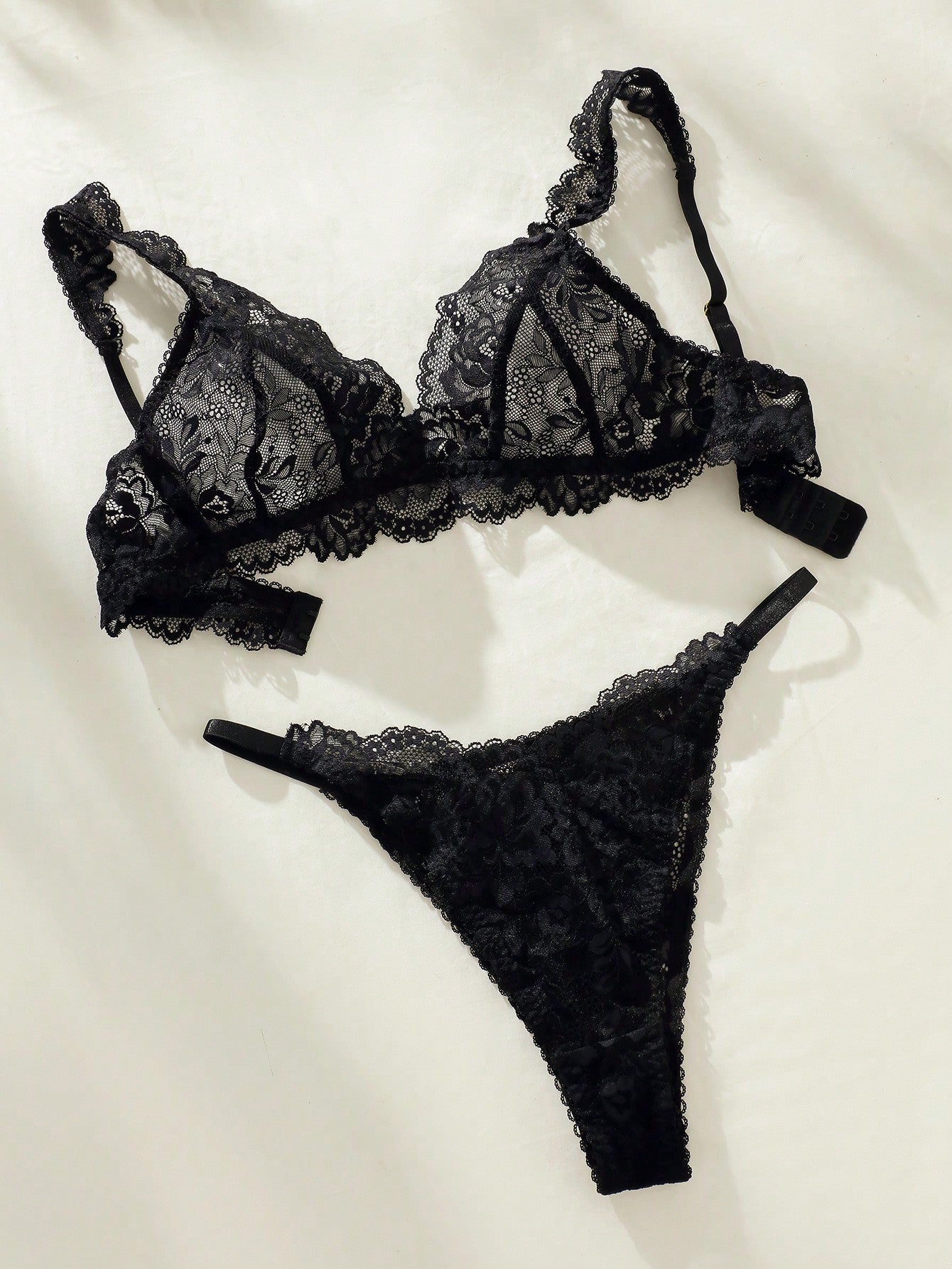 Women's floral lace lingerie set featuring a camisole-style wireless bra with adjustable straps and matching mid-rise briefs, designed with contrast scalloped lace and light support.