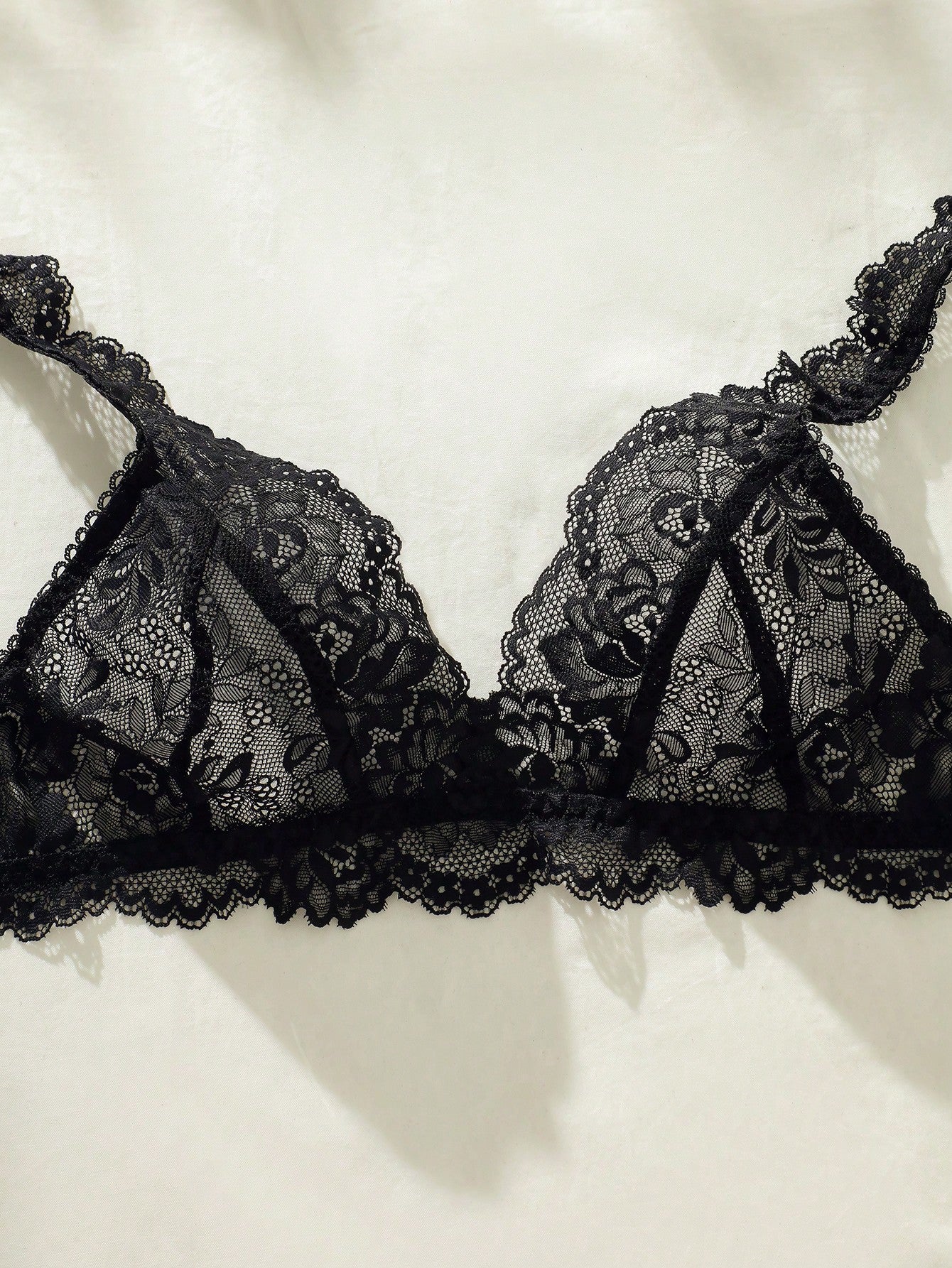 Women's floral lace lingerie set featuring a camisole-style wireless bra with adjustable straps and matching mid-rise briefs, designed with contrast scalloped lace and light support.