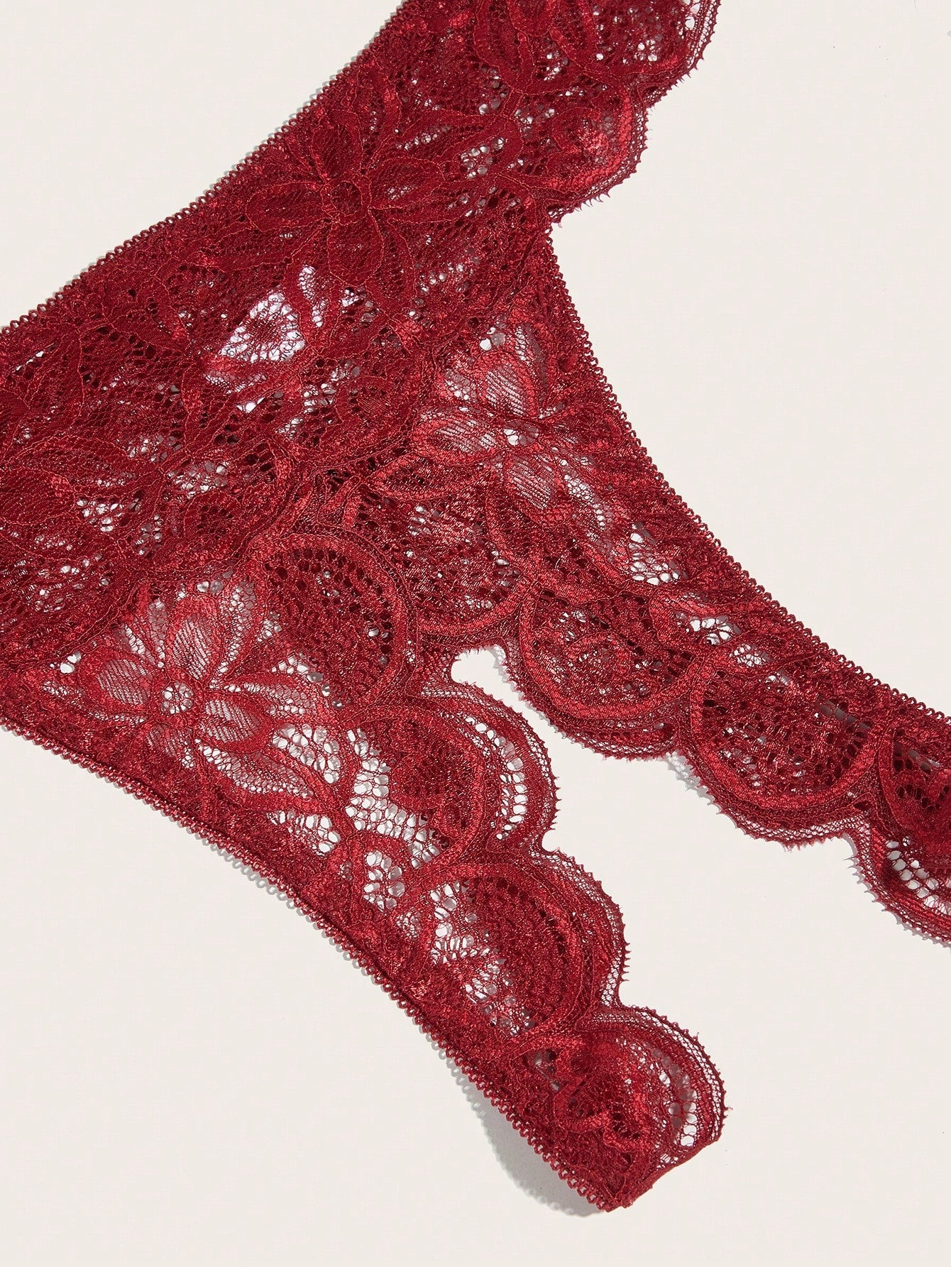 Burgundy floral lace lingerie set with scallop trim, cut-out detail, adjustable spaghetti straps, a bralette-style top, and mid-rise thong bottoms.