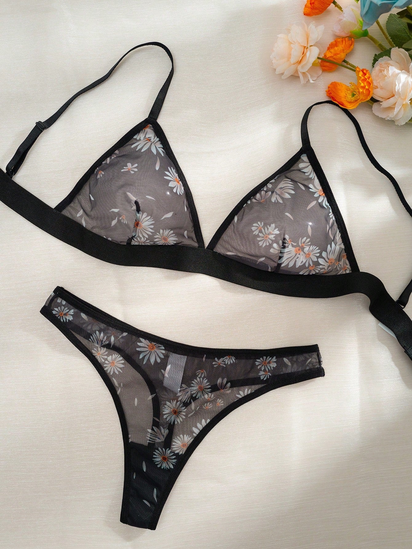 Women’s 2-piece lingerie set featuring a wireless bralette and matching low-rise G-string thong with adjustable straps, contrast binding, and an all-over multicolor animal-inspired print.