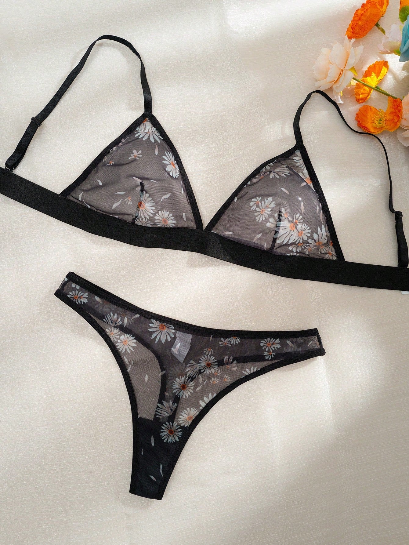 Women’s 2-piece lingerie set featuring a wireless bralette and matching low-rise G-string thong with adjustable straps, contrast binding, and an all-over multicolor animal-inspired print.