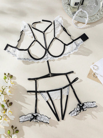 Two-piece white floral lace lingerie set with underwire cups, spaghetti straps, and matching V-string panty with garter-style details; sheer fabric with slight stretch.