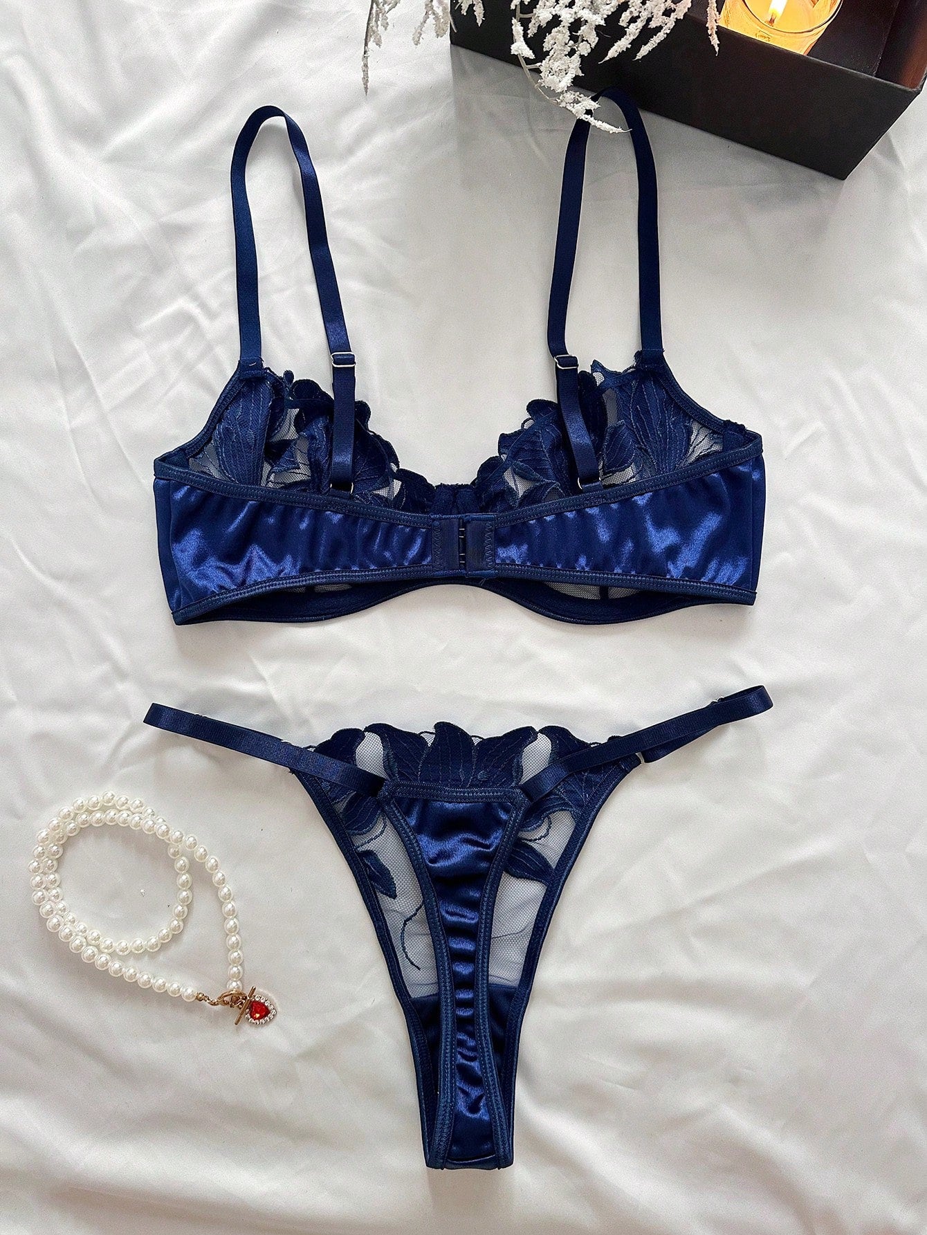 Women’s 2-piece sexy lingerie set featuring an embroidered sheer mesh demi bra with adjustable spaghetti straps and a matching low-rise thong.