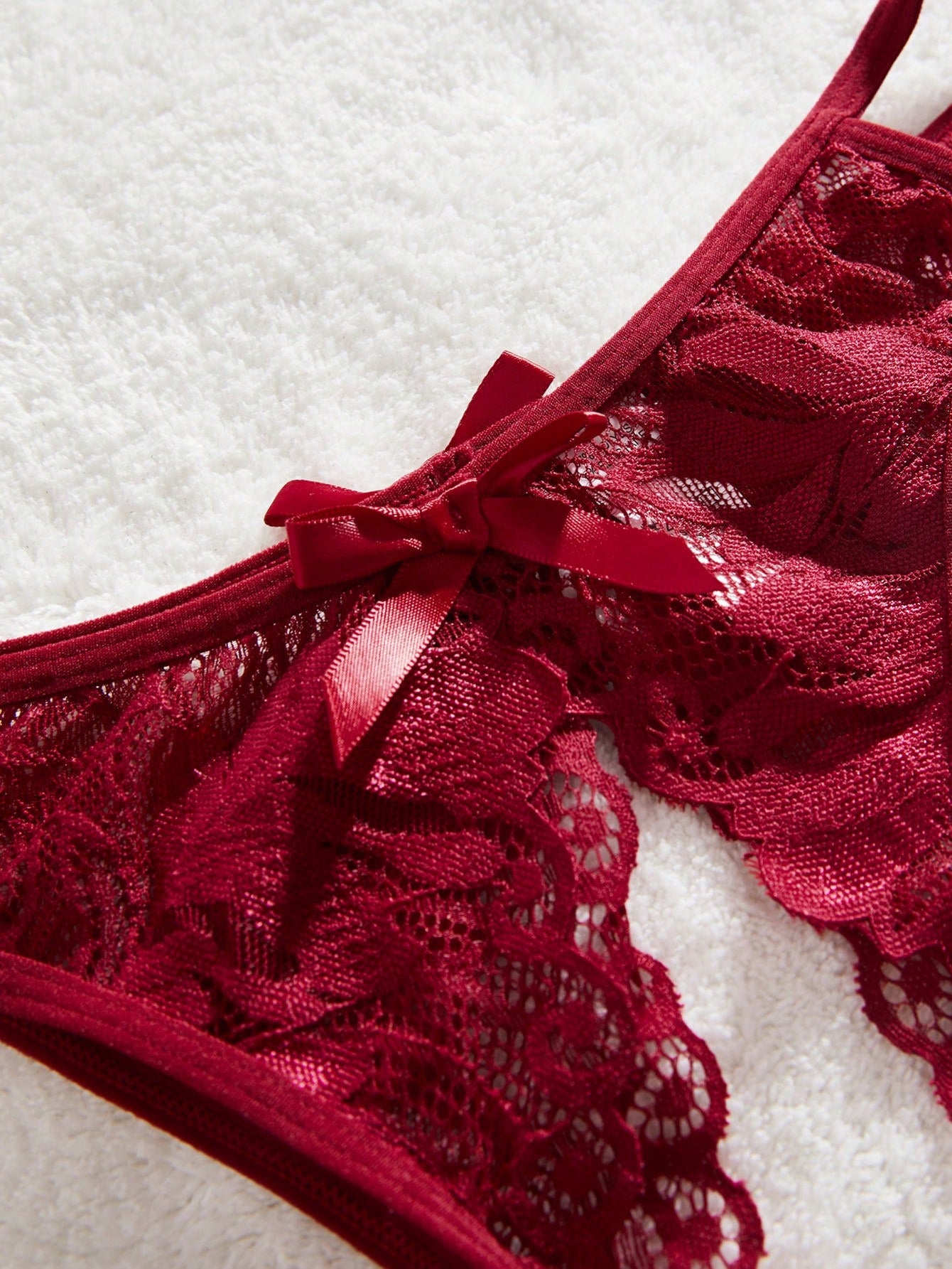 Burgundy floral lace 2-piece lingerie set with a bralette top and low-rise briefs, featuring a cut-out crotchless design, spaghetti straps, and adjustable straps.