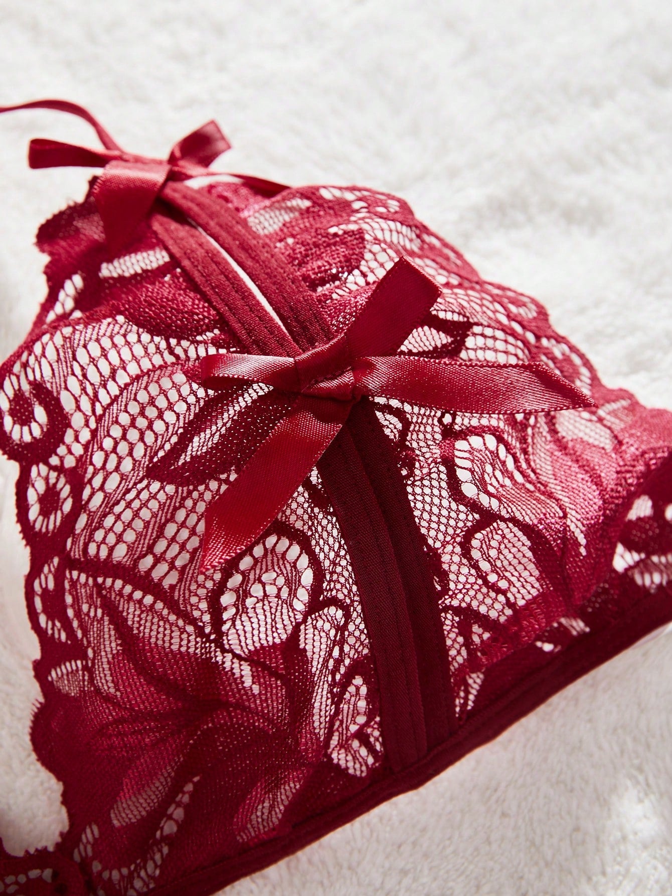 Burgundy floral lace 2-piece lingerie set with a bralette top and low-rise briefs, featuring a cut-out crotchless design, spaghetti straps, and adjustable straps.