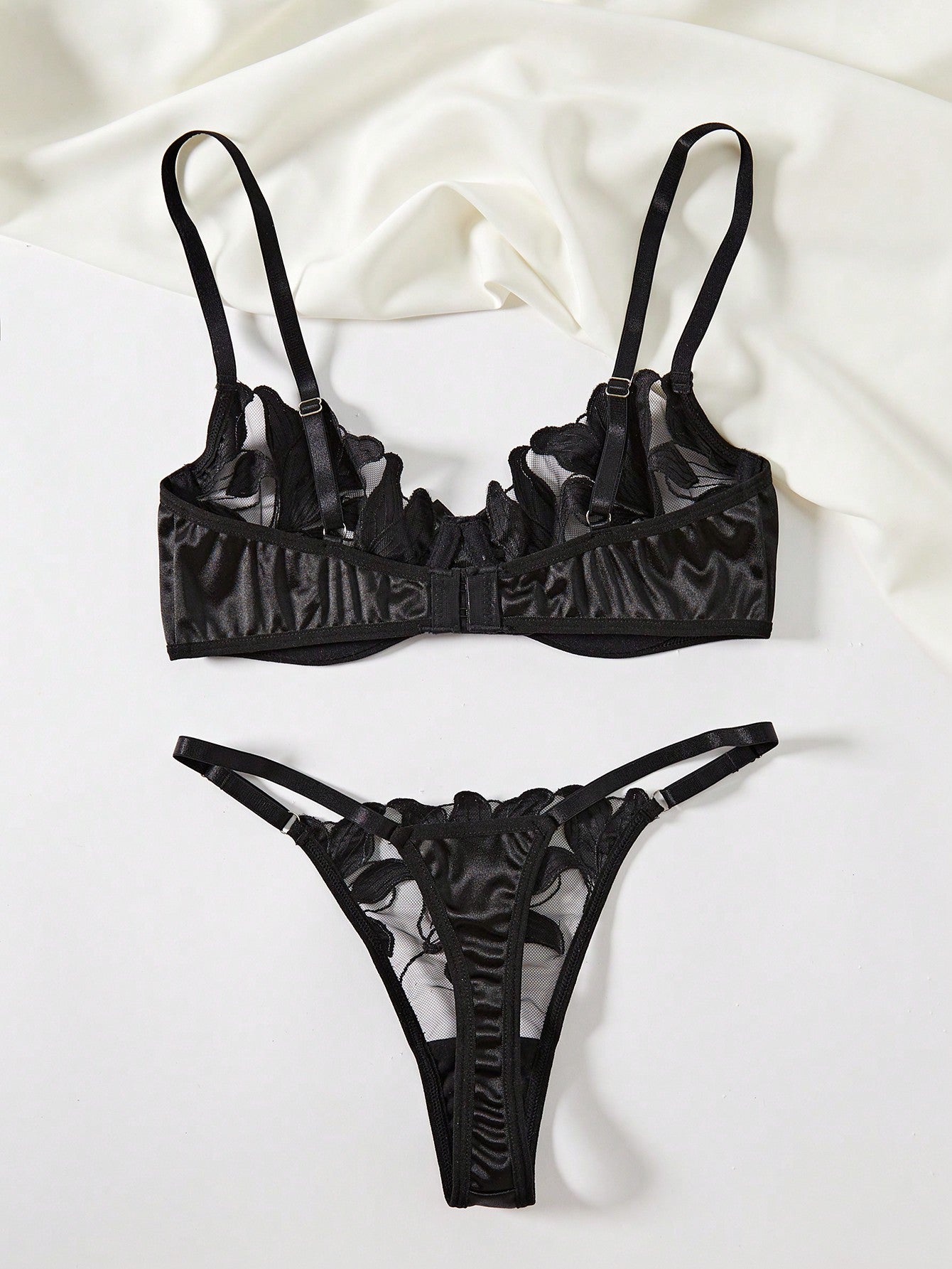 Women’s 2-piece sexy lingerie set featuring an embroidered sheer mesh demi bra with adjustable spaghetti straps and a matching low-rise thong.