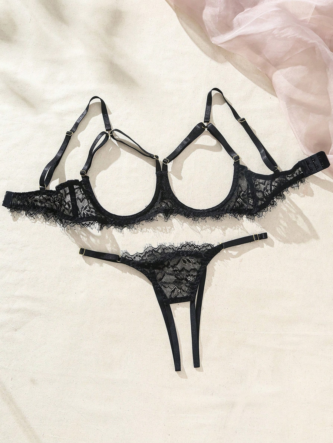 Two-piece goth-style floral lace lingerie set featuring a triangle bra with adjustable spaghetti straps, cut-out harness detailing, and a matching mid-rise thong.