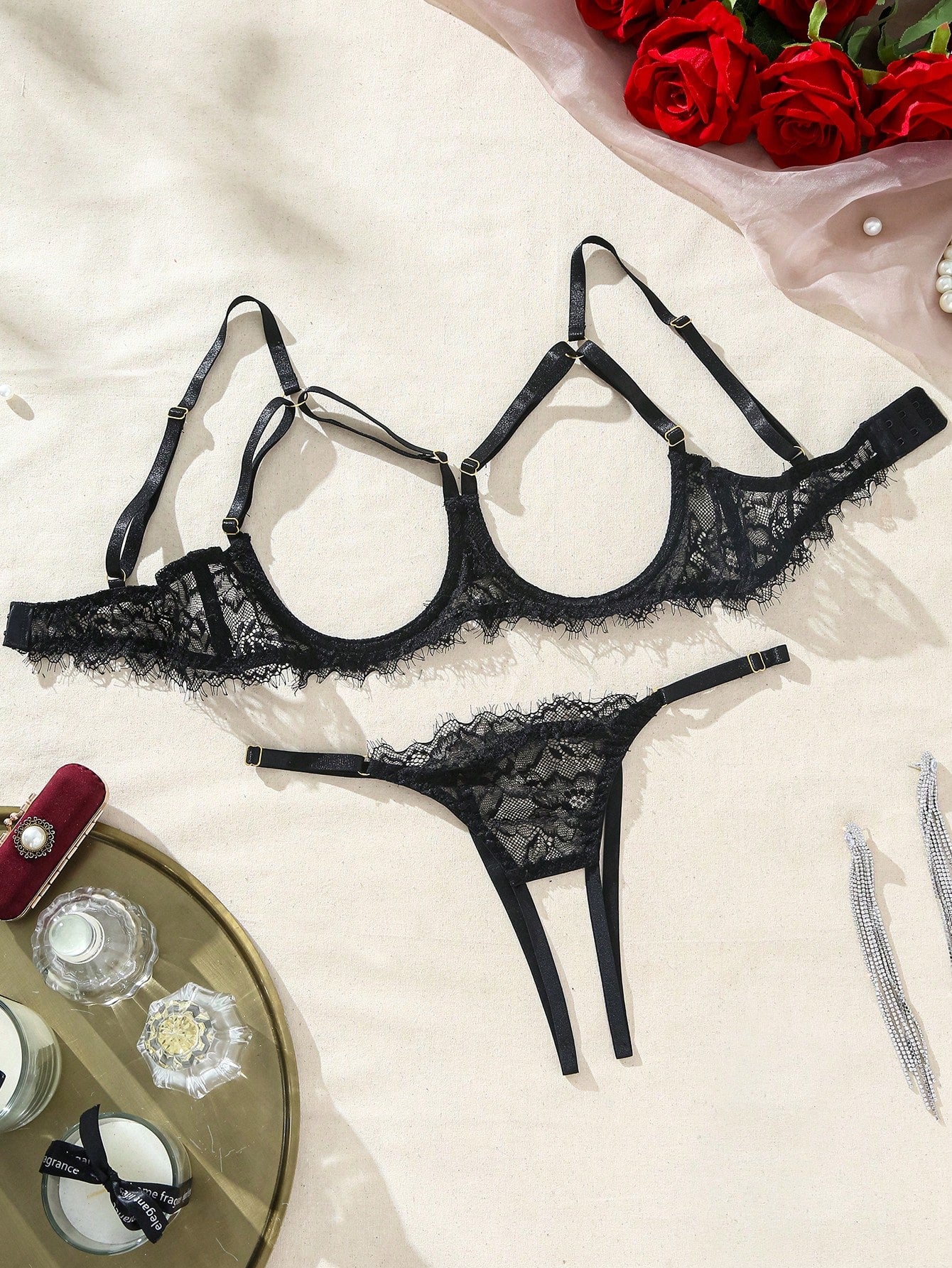Two-piece goth-style floral lace lingerie set featuring a triangle bra with adjustable spaghetti straps, cut-out harness detailing, and a matching mid-rise thong.