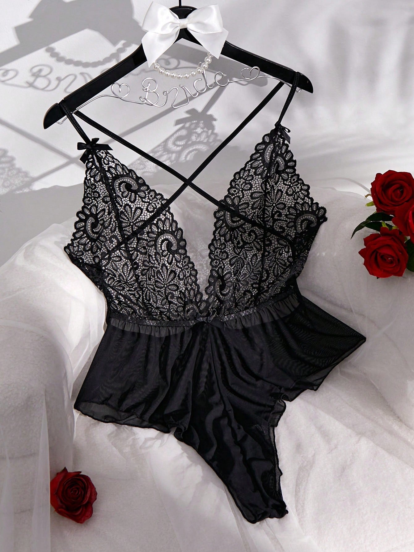 Sheer mesh teddy bodysuit lingerie with contrast lace detailing, spaghetti straps, criss-cross back, backless design, bow accent, and V-string cut.