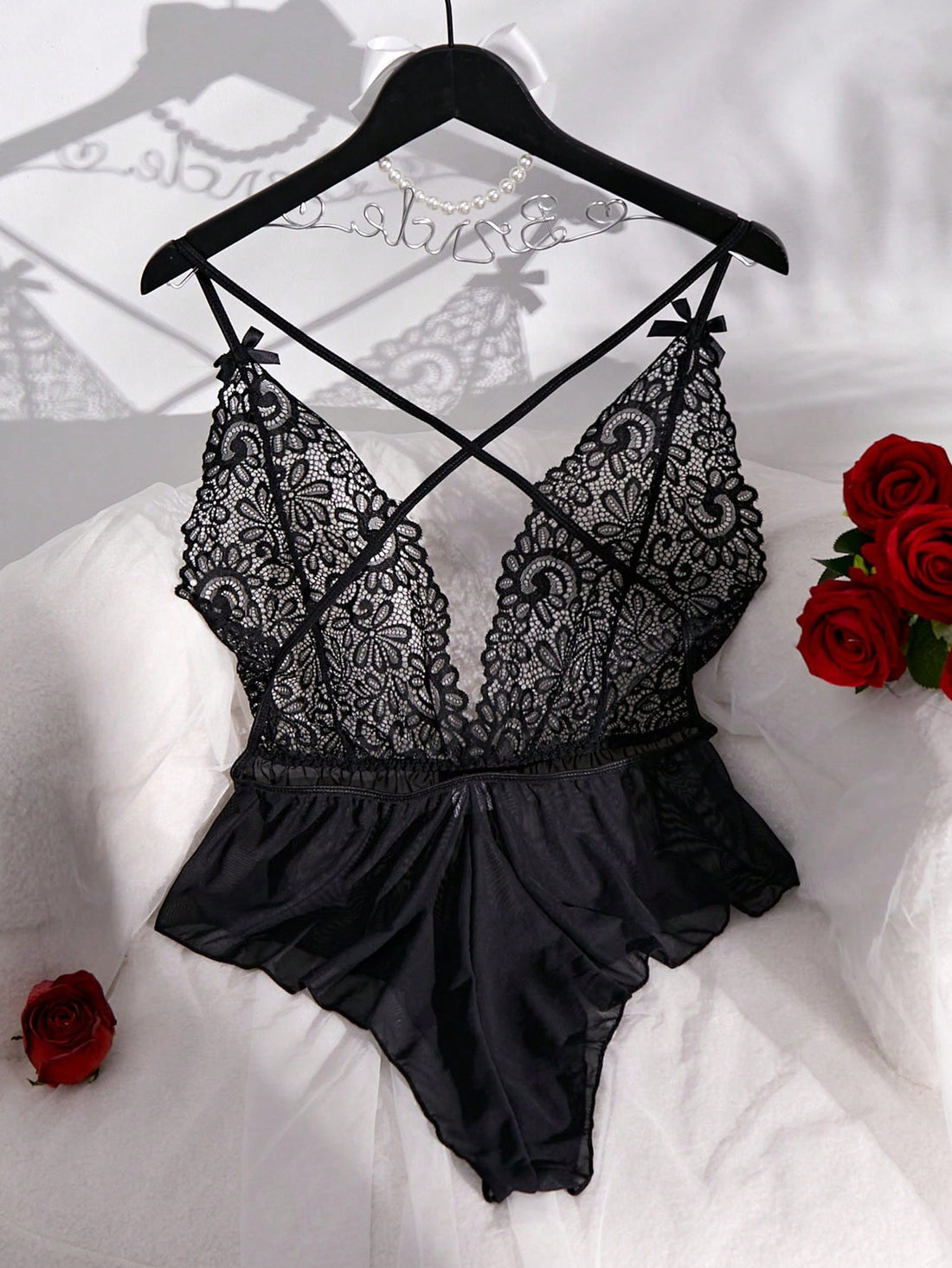 Sheer mesh teddy bodysuit lingerie with contrast lace detailing, spaghetti straps, criss-cross back, backless design, bow accent, and V-string cut.