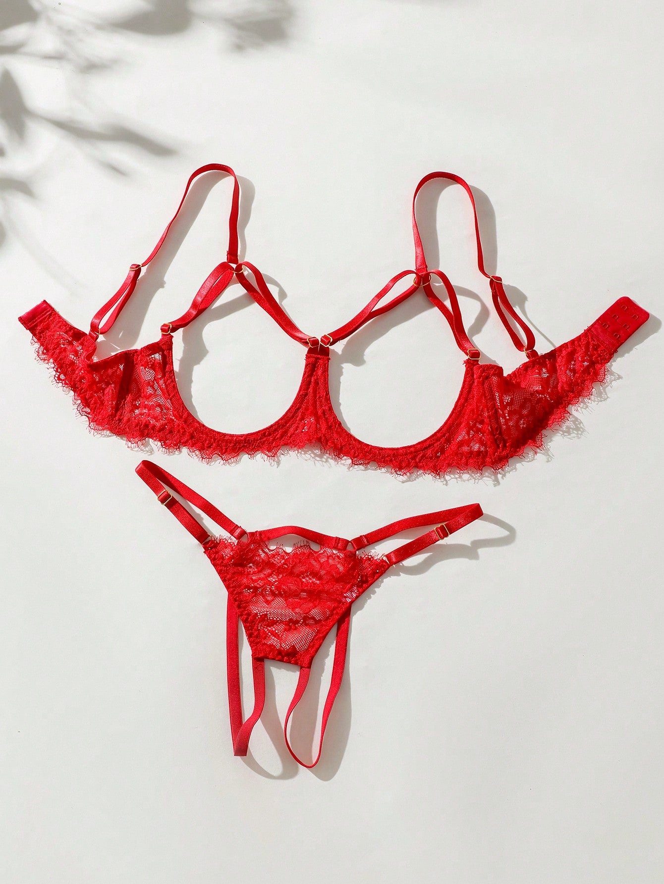 Two-piece goth-style floral lace lingerie set featuring a triangle bra with adjustable spaghetti straps, cut-out harness detailing, and a matching mid-rise thong.