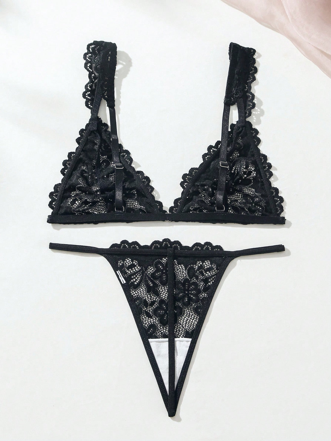 Women’s lace lingerie set with an underwire triangle bra, adjustable spaghetti straps, and matching mid-rise V-string panty in plain design; available in black and rust brown.