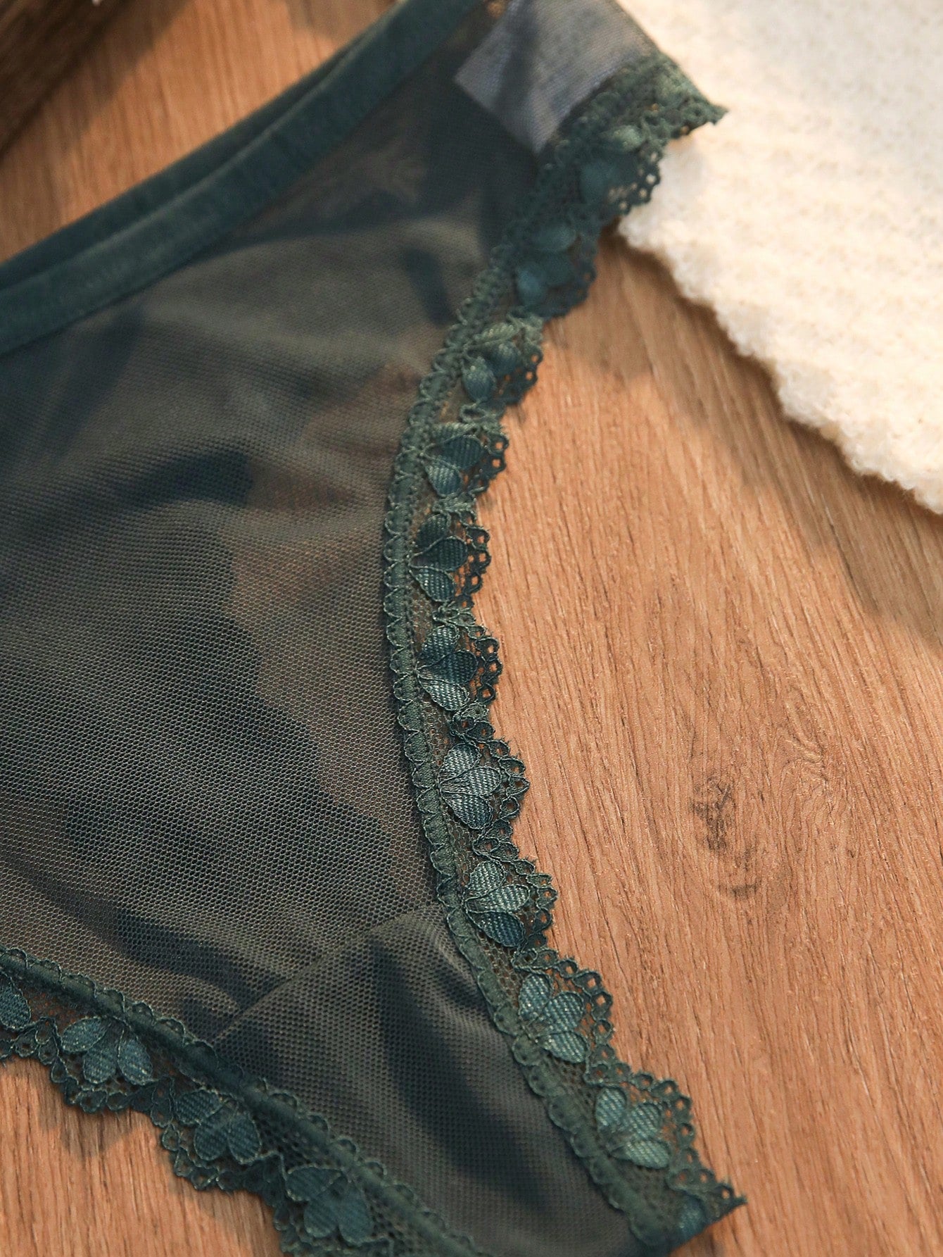 Dark green 2-piece lingerie set featuring a lace and mesh underwire bralette with adjustable straps and a matching mid-rise thong.