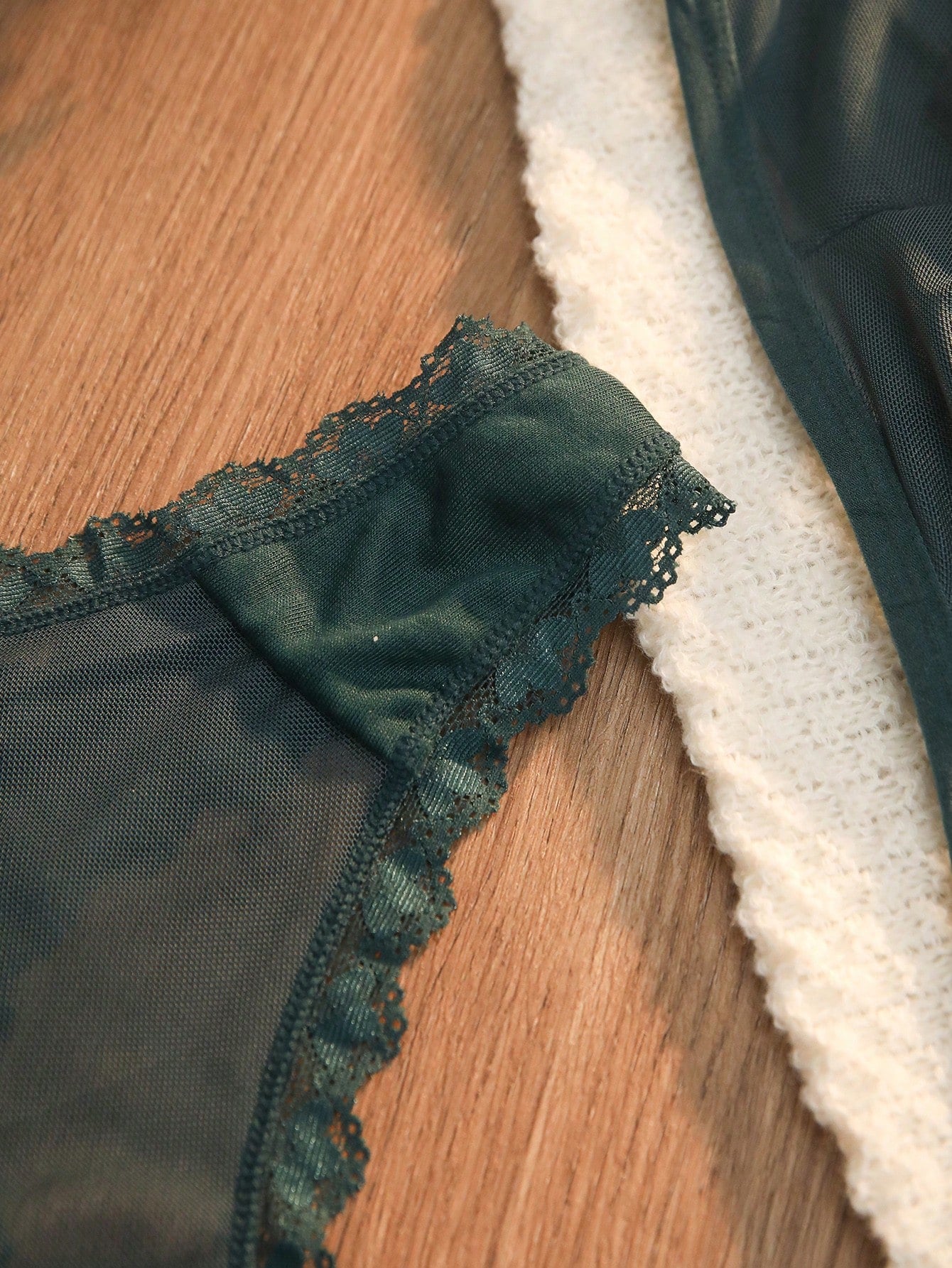 Dark green 2-piece lingerie set featuring a lace and mesh underwire bralette with adjustable straps and a matching mid-rise thong.