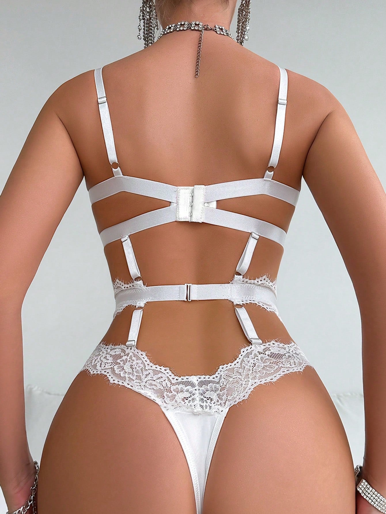 Women's lace splice bodysuit lingerie set with cut-out details, adjustable spaghetti straps, underwire full cups, high-rise thong bottom, and classic sexy styling.