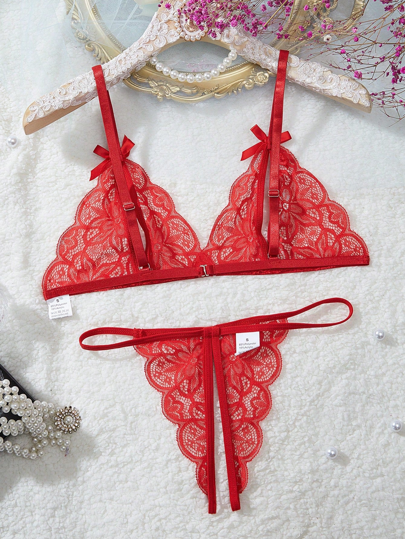 Two-piece floral lace cut-out lingerie set featuring a spaghetti strap bralette with adjustable straps and a matching low-rise V-string panty.