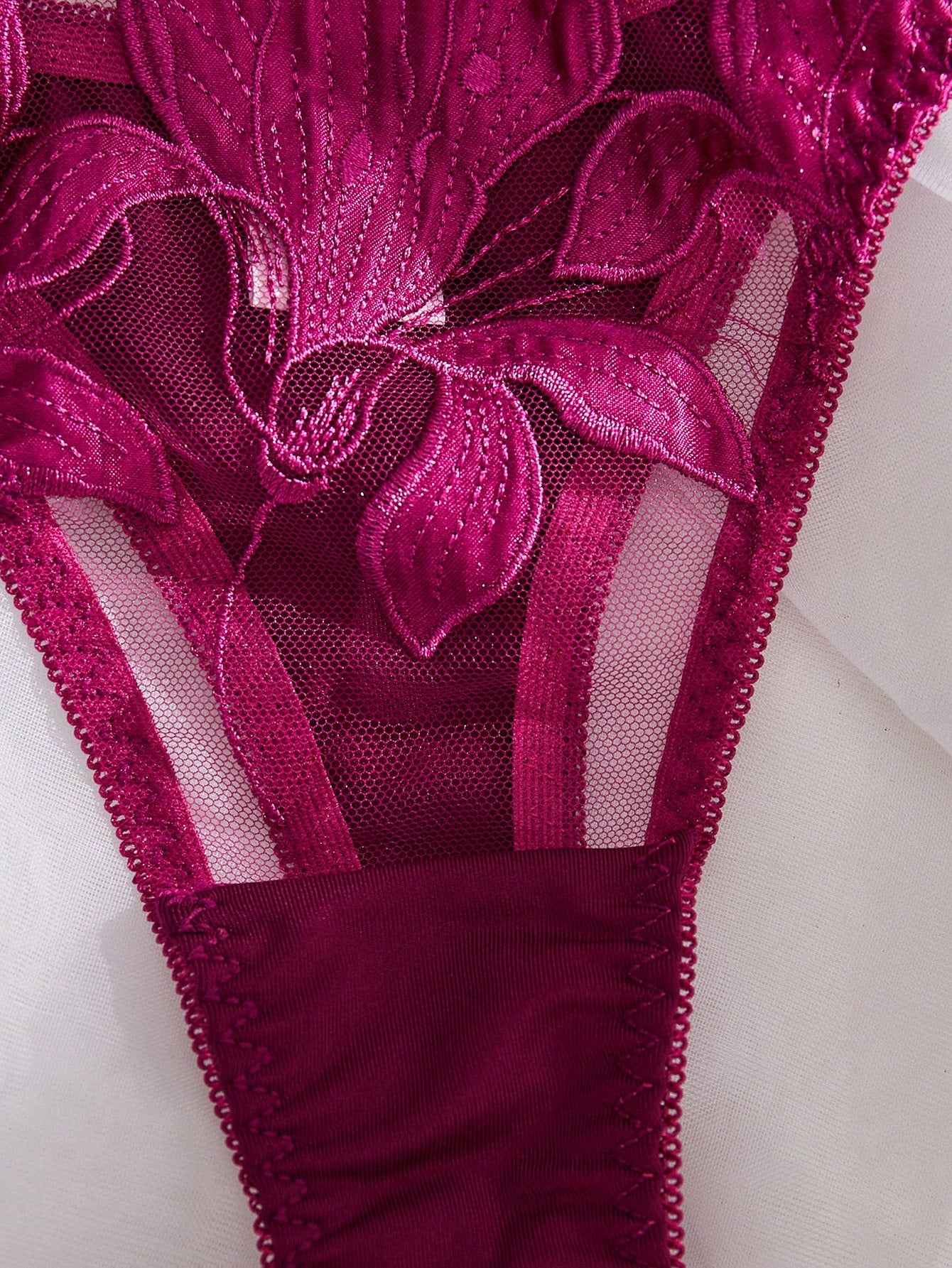 Purple 2-piece women’s lingerie set with embroidered floral details, featuring an underwire bra with adjustable straps and a matching low-rise thong in semi-sheer mesh.