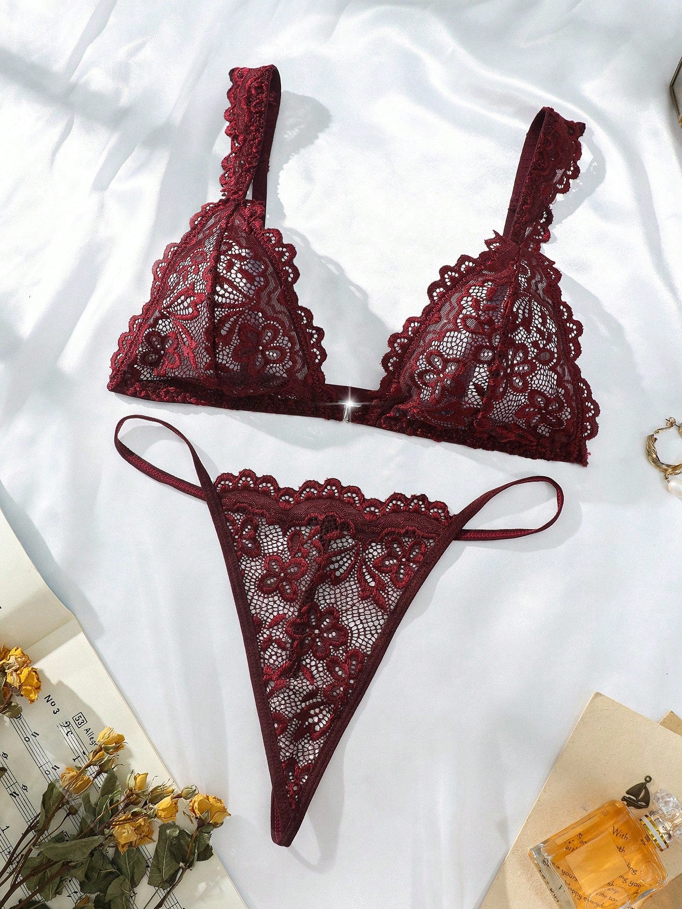 Women’s lace lingerie set with an underwire triangle bra, adjustable spaghetti straps, and matching mid-rise V-string panty in plain design; available in black and rust brown.