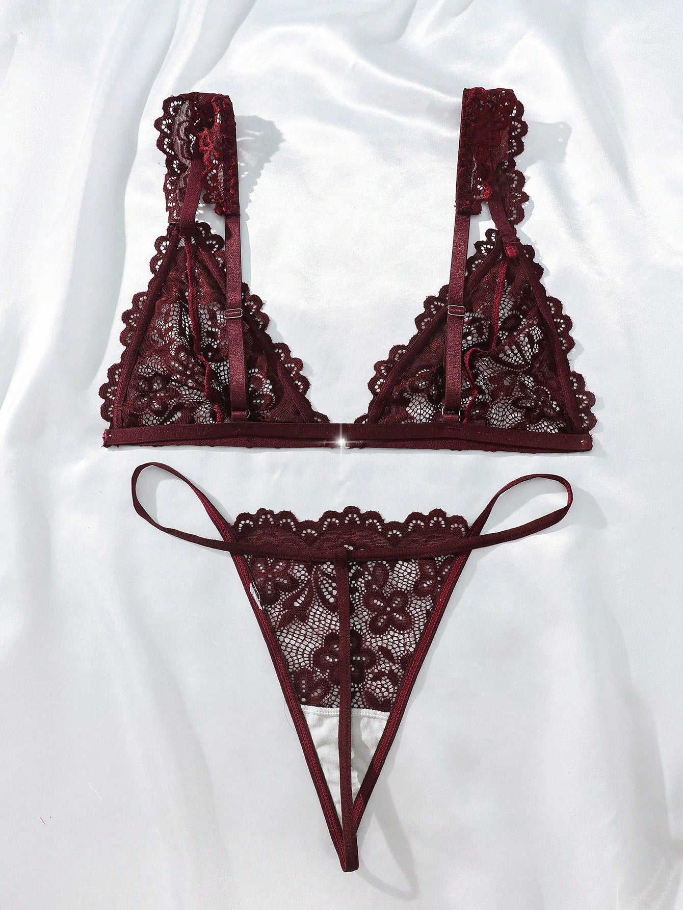 Women’s lace lingerie set with an underwire triangle bra, adjustable spaghetti straps, and matching mid-rise V-string panty in plain design; available in black and rust brown.