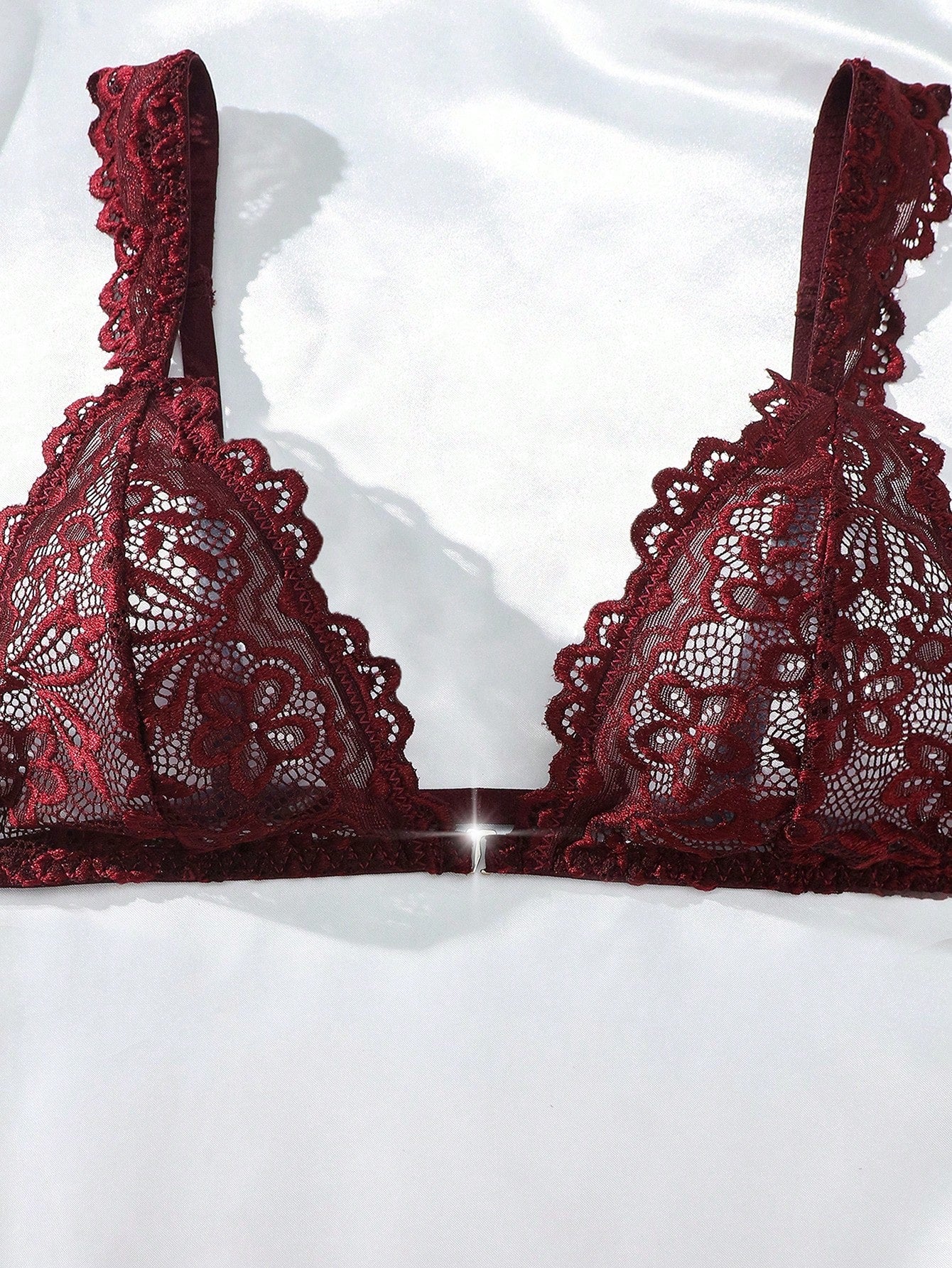 Women’s lace lingerie set with an underwire triangle bra, adjustable spaghetti straps, and matching mid-rise V-string panty in plain design; available in black and rust brown.