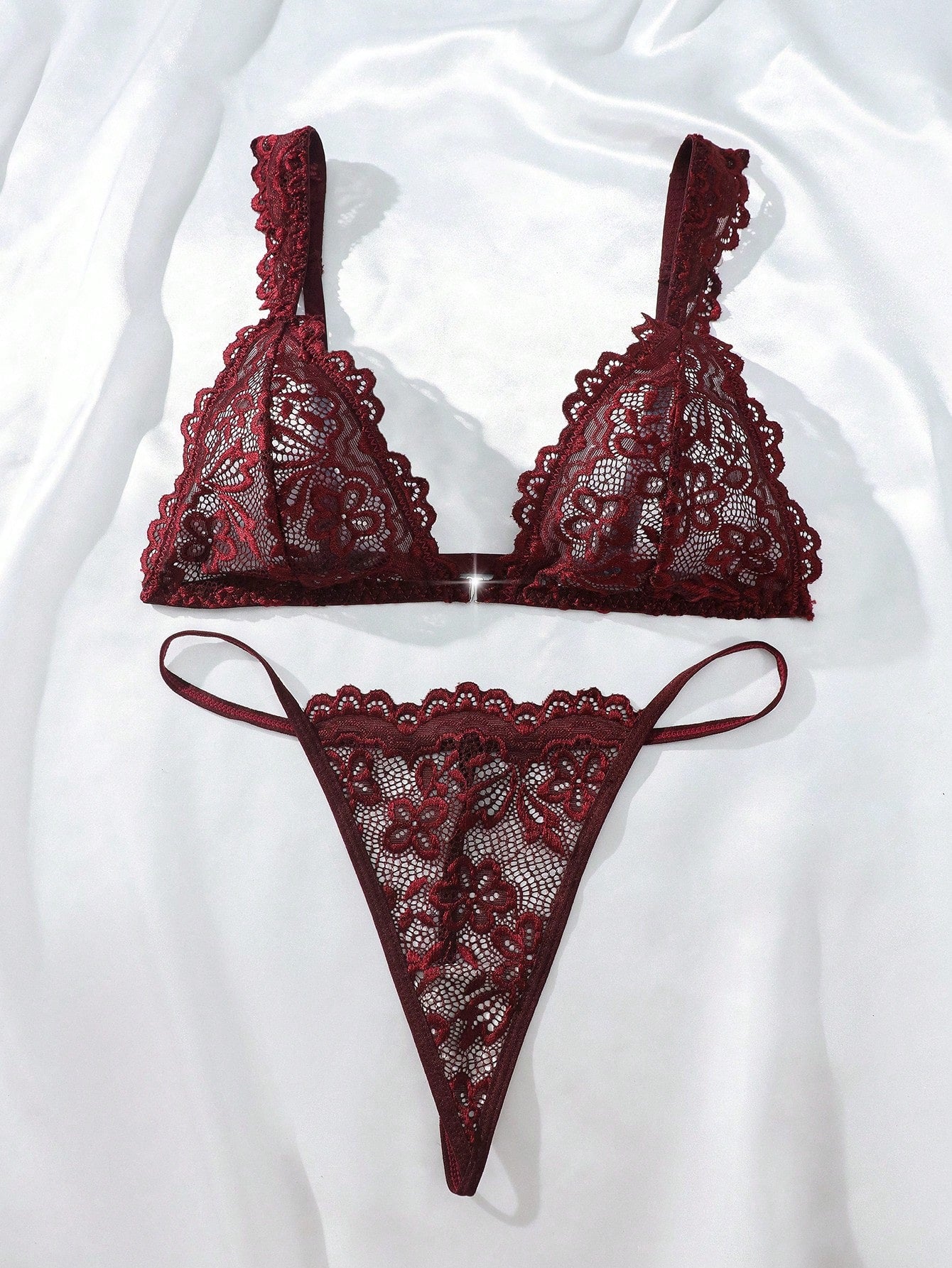 Women’s lace lingerie set with an underwire triangle bra, adjustable spaghetti straps, and matching mid-rise V-string panty in plain design; available in black and rust brown.