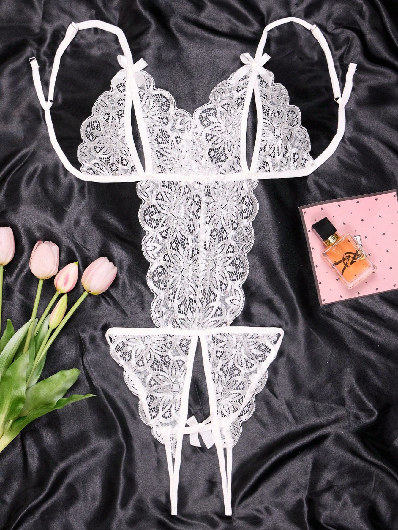 1-piece women’s lace bodysuit featuring an open crotch design, backless cut, exposed bust, underwire 1/2 cup bralette, adjustable spaghetti straps, thong back, and a body-shaping fit.