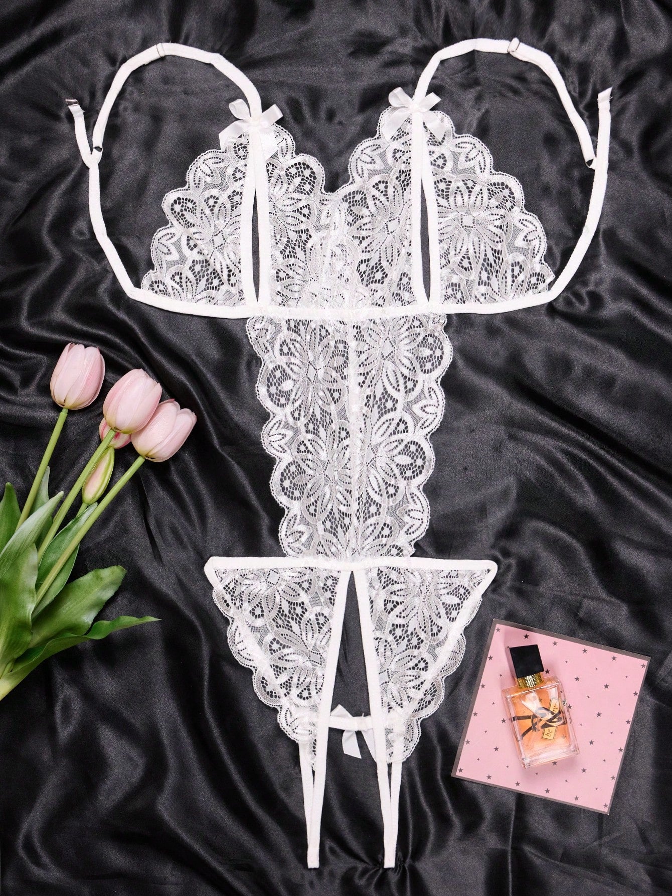 1-piece women’s lace bodysuit featuring an open crotch design, backless cut, exposed bust, underwire 1/2 cup bralette, adjustable spaghetti straps, thong back, and a body-shaping fit.