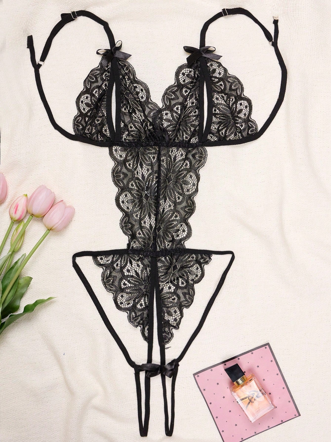 1-piece women’s lace bodysuit featuring an open crotch design, backless cut, exposed bust, underwire 1/2 cup bralette, adjustable spaghetti straps, thong back, and a body-shaping fit.