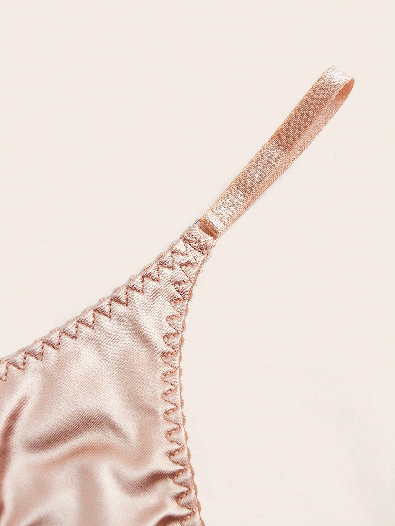 Two-piece minimalist solid color lingerie set featuring a wireless bralette with adjustable straps and removable padding, paired with a low-rise thong. Plain, unlined, and no-show style with slight stretch. Available in Apricot and Black.