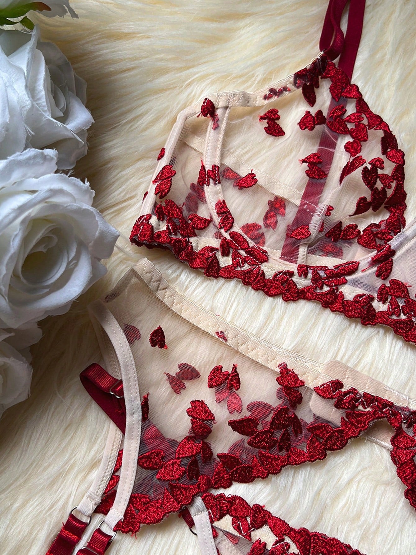 Red women's 2-piece lingerie set with embroidered mesh heart-shaped detail, featuring a wireless triangle bralette with spaghetti straps and matching mid-rise thong.