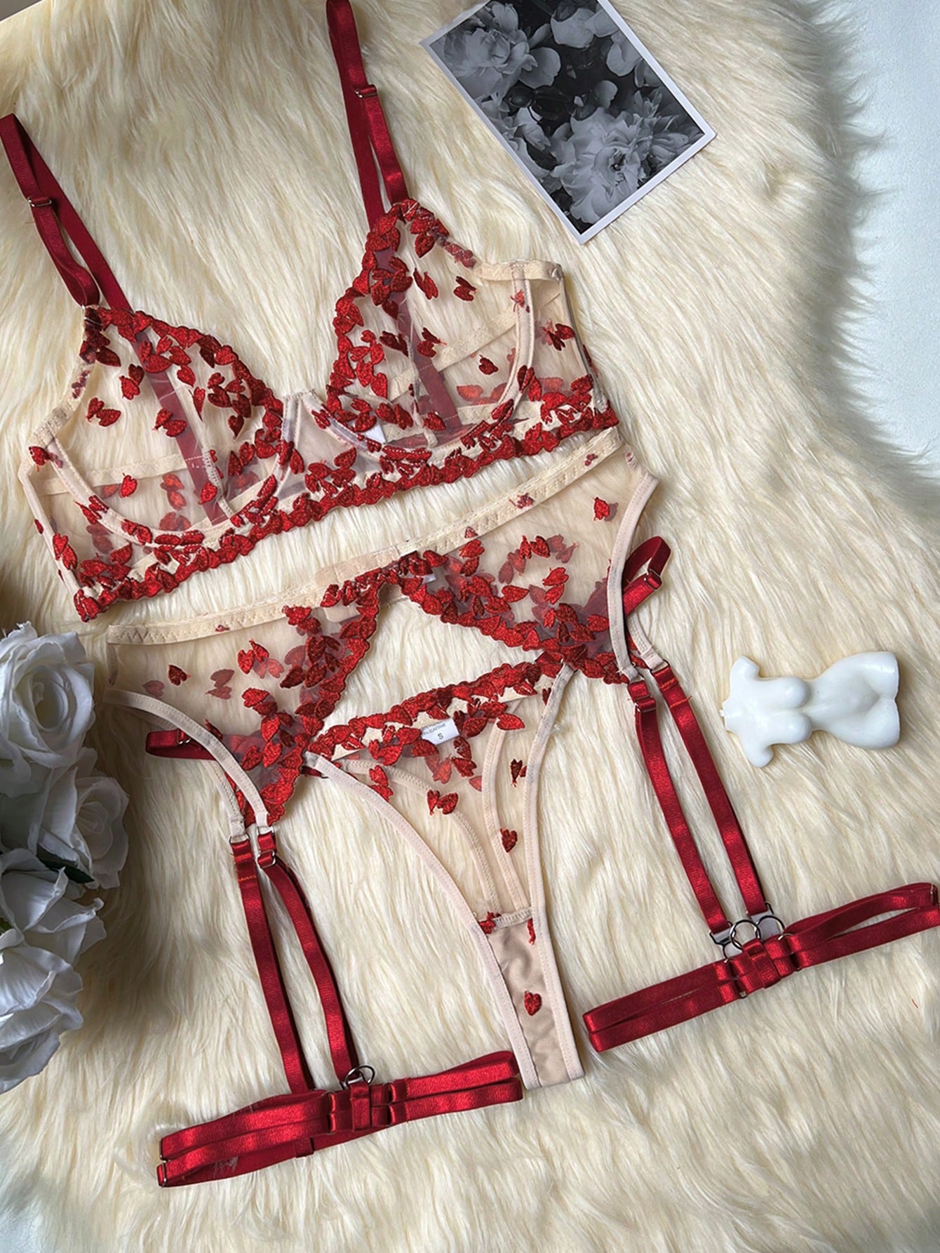 Red women's 2-piece lingerie set with embroidered mesh heart-shaped detail, featuring a wireless triangle bralette with spaghetti straps and matching mid-rise thong.