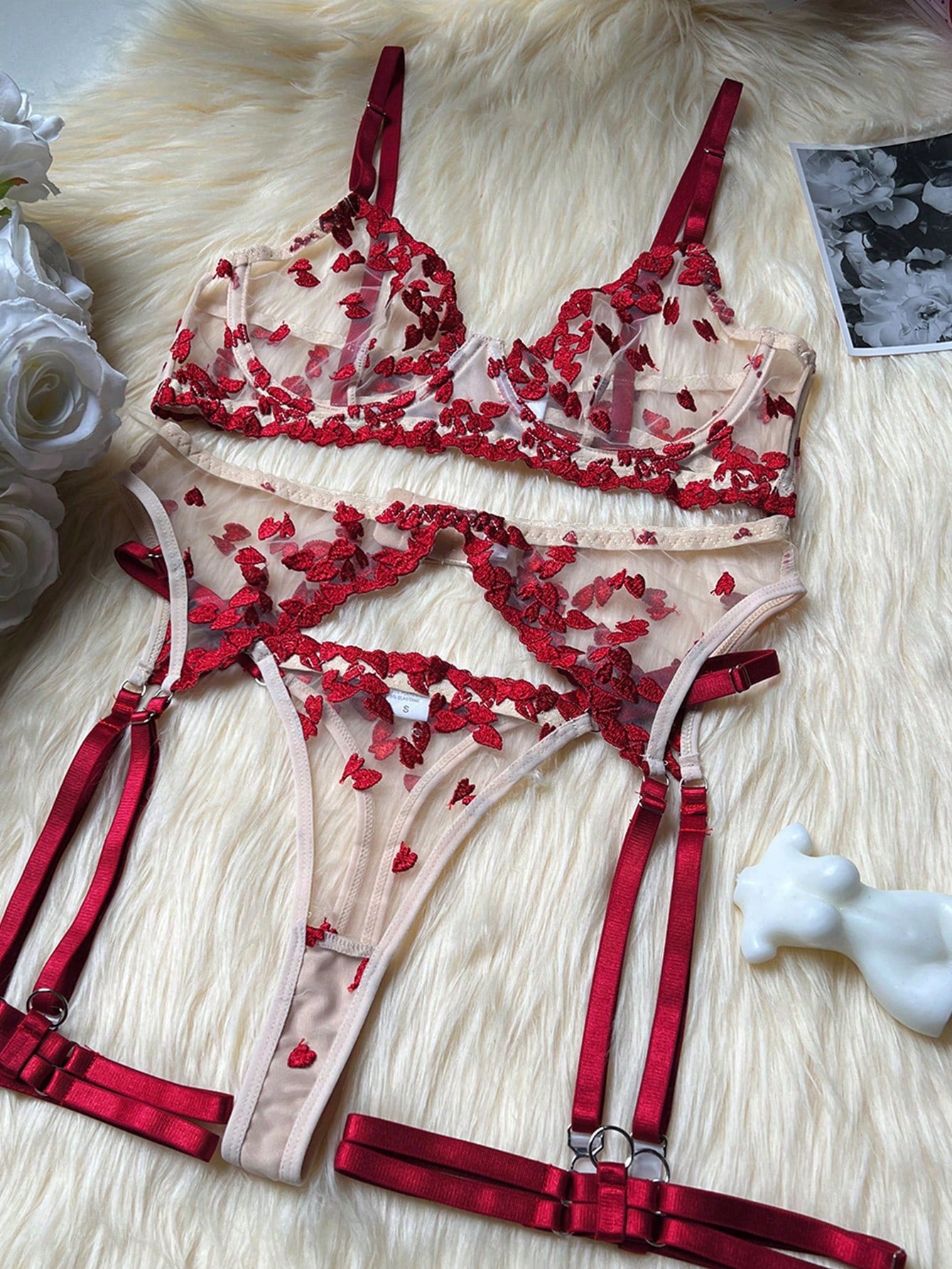 Red women's 2-piece lingerie set with embroidered mesh heart-shaped detail, featuring a wireless triangle bralette with spaghetti straps and matching mid-rise thong.