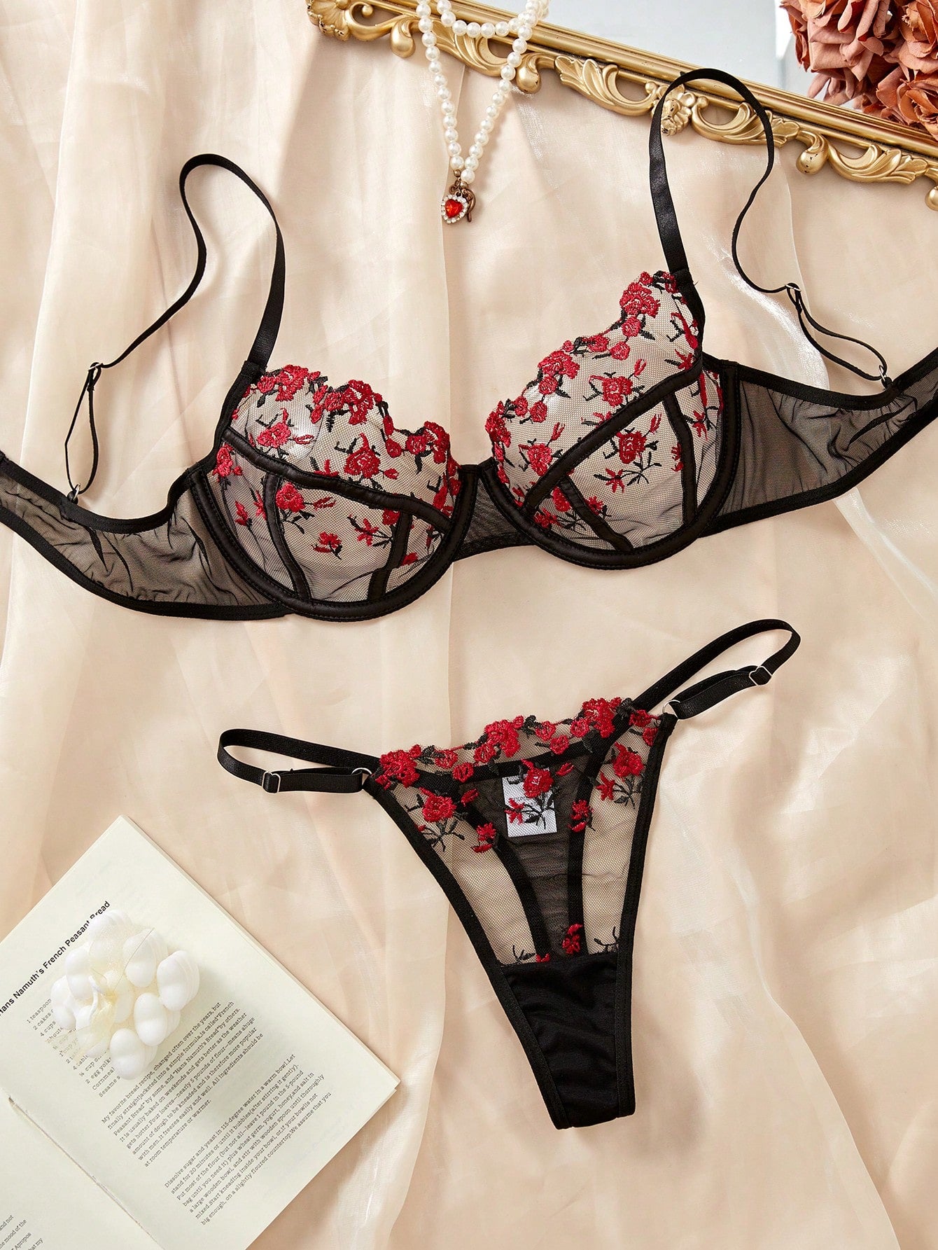 Women's black and red embroidered sheer lingerie set featuring an underwire bra with adjustable straps and a matching low-rise thong, 2-piece set.