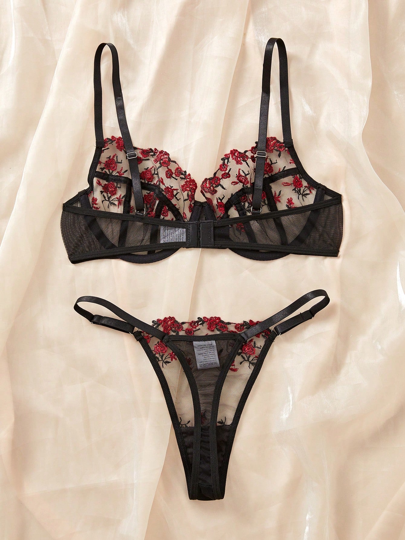 Women's black and red embroidered sheer lingerie set featuring an underwire bra with adjustable straps and a matching low-rise thong, 2-piece set.