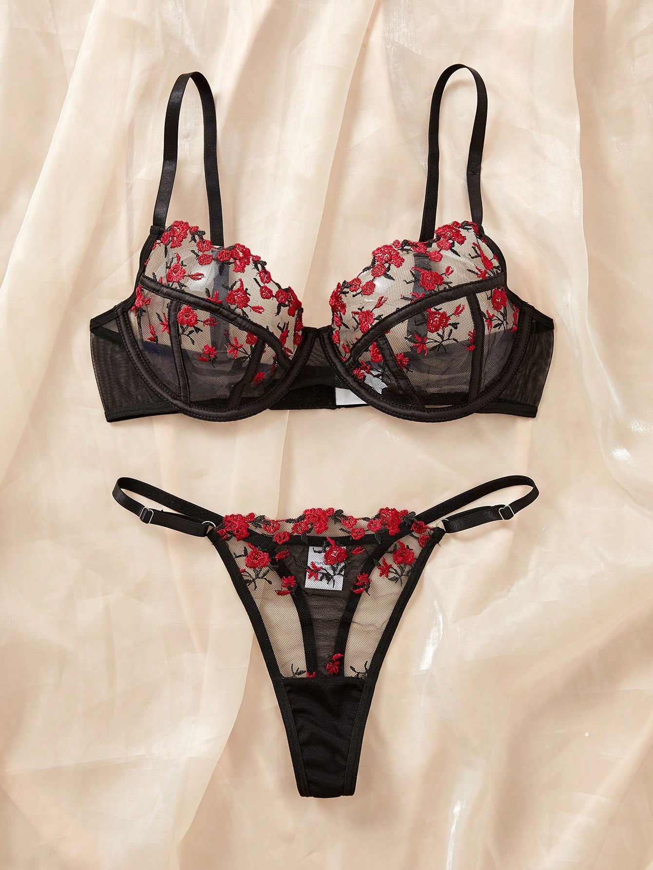 Women's black and red embroidered sheer lingerie set featuring an underwire bra with adjustable straps and a matching low-rise thong, 2-piece set.