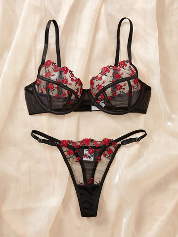 Women's black and red embroidered sheer lingerie set featuring an underwire bra with adjustable straps and a matching low-rise thong, 2-piece set.