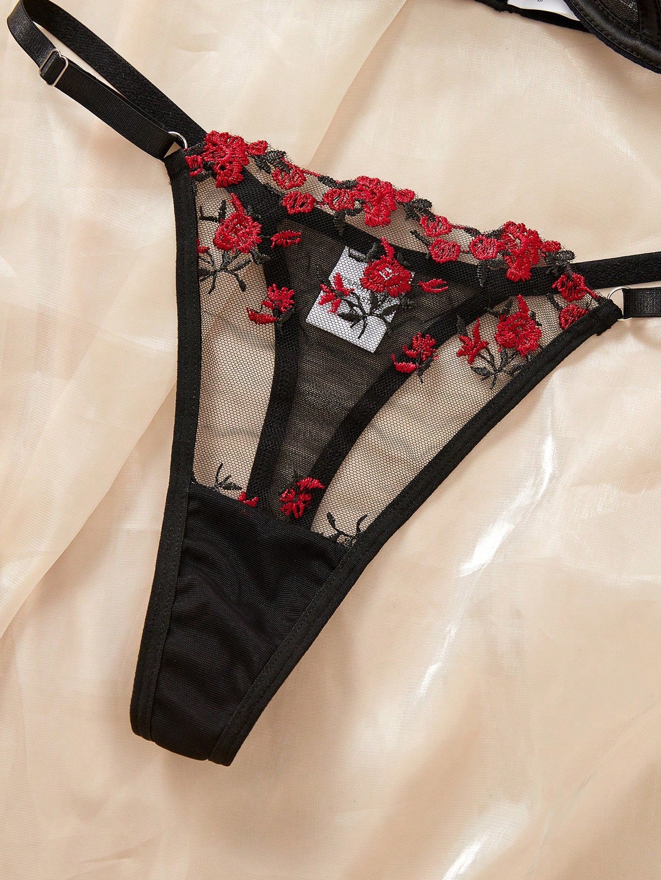 Women's black and red embroidered sheer lingerie set featuring an underwire bra with adjustable straps and a matching low-rise thong, 2-piece set.
