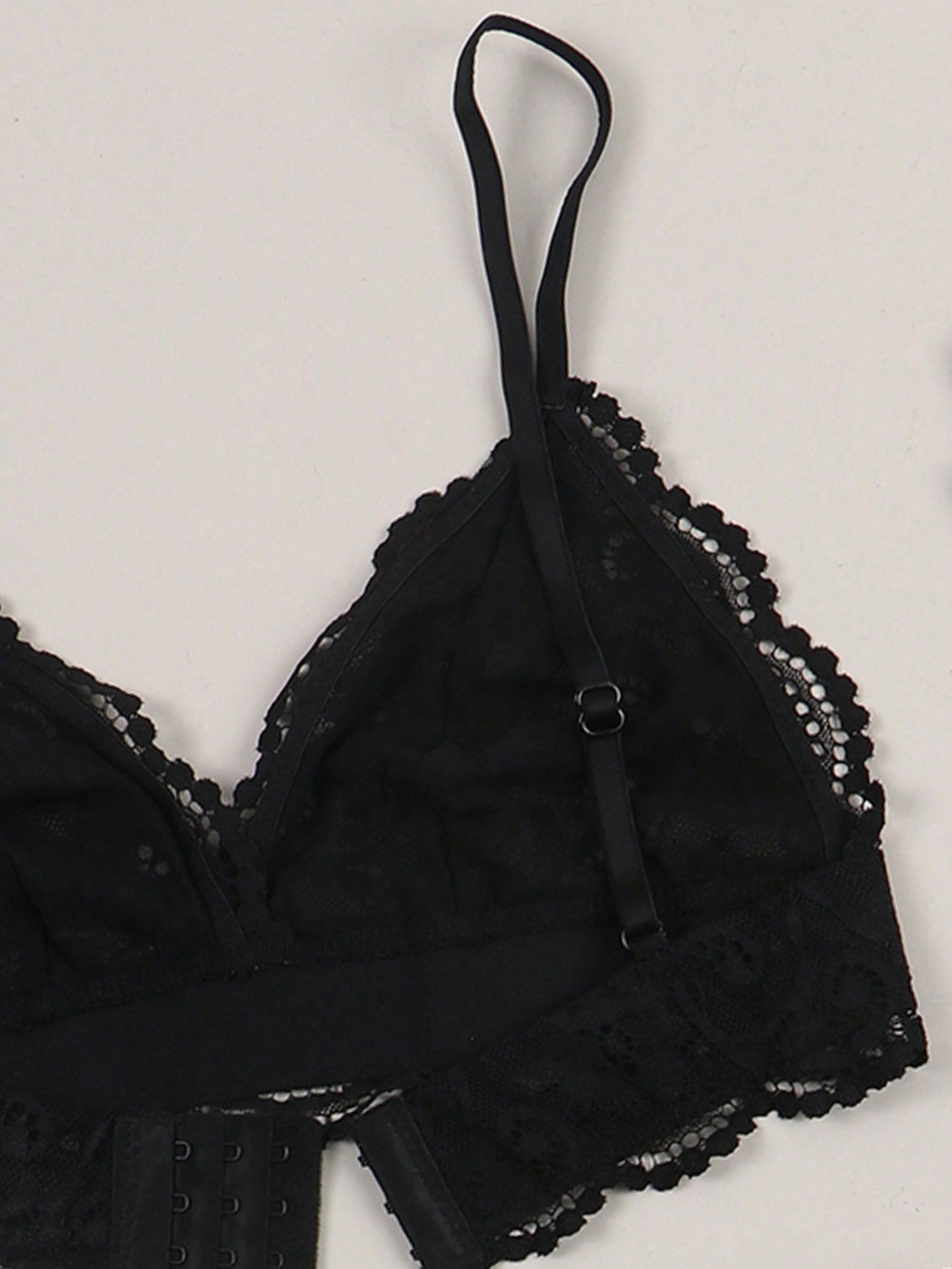 Women’s floral lace garter lingerie 4-piece set with a plunge wireless bra, adjustable straps, low-rise hipster panty, and cut-out details.