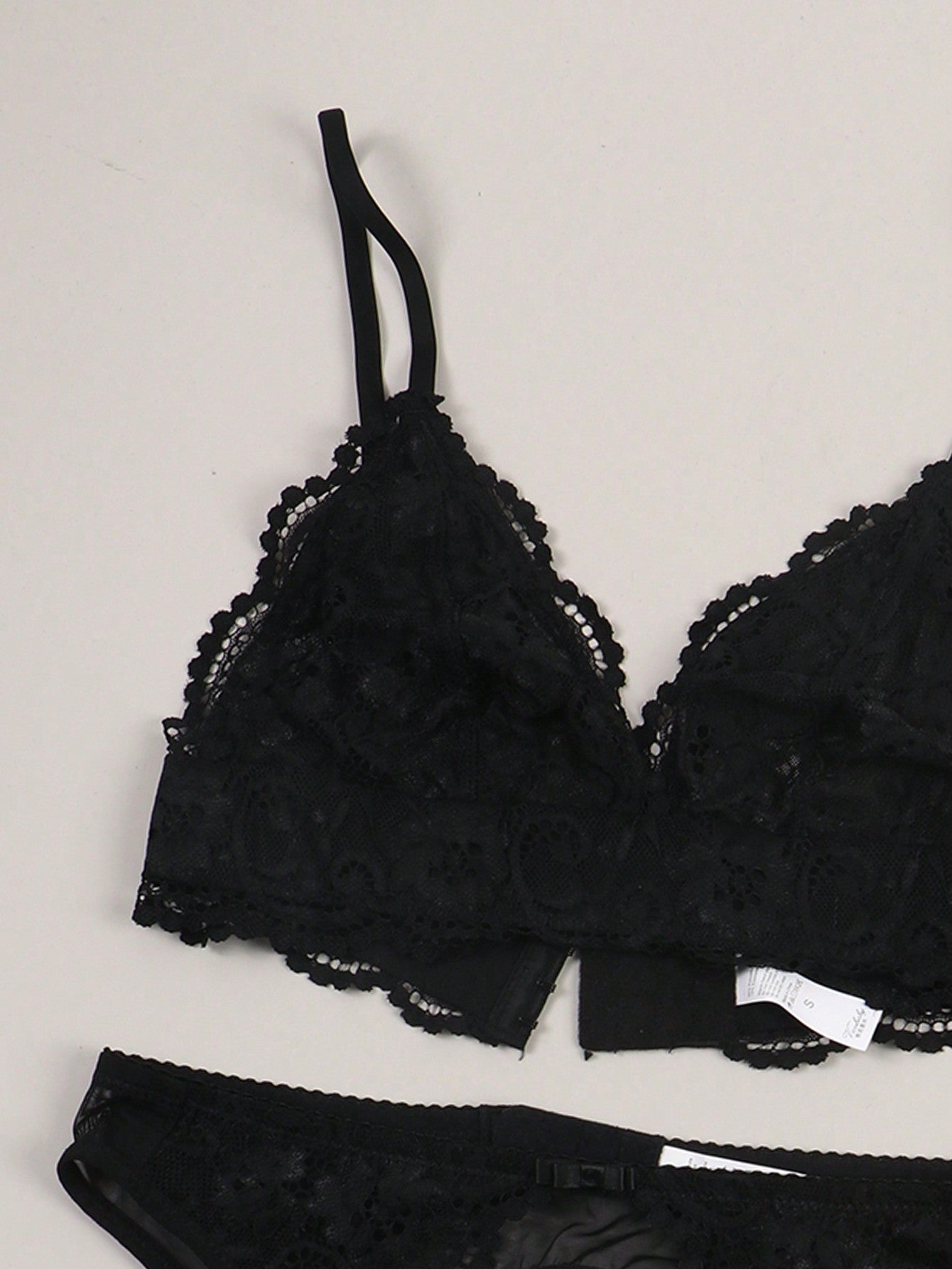 Women’s floral lace garter lingerie 4-piece set with a plunge wireless bra, adjustable straps, low-rise hipster panty, and cut-out details.