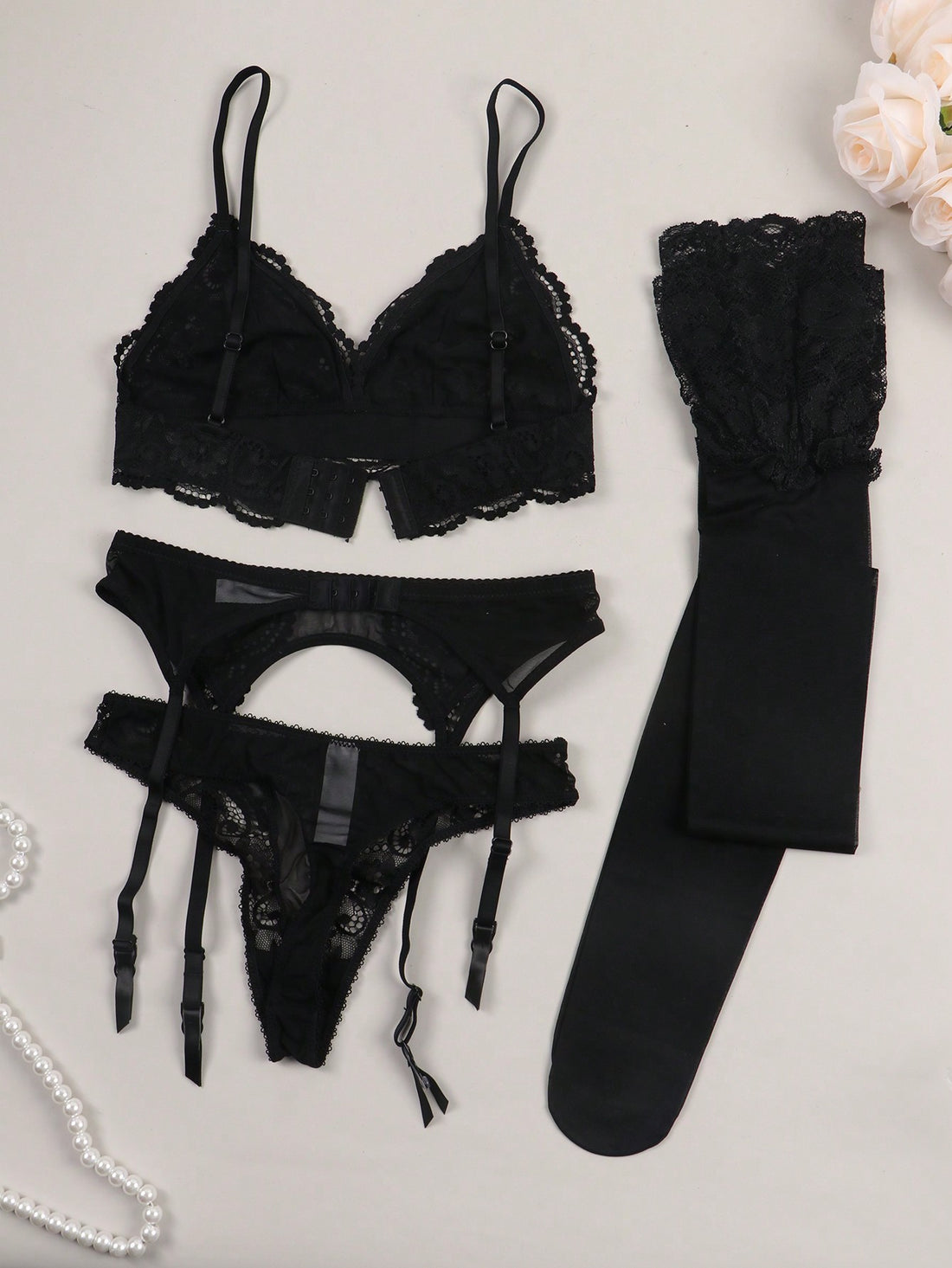 Women’s floral lace garter lingerie 4-piece set with a plunge wireless bra, adjustable straps, low-rise hipster panty, and cut-out details.